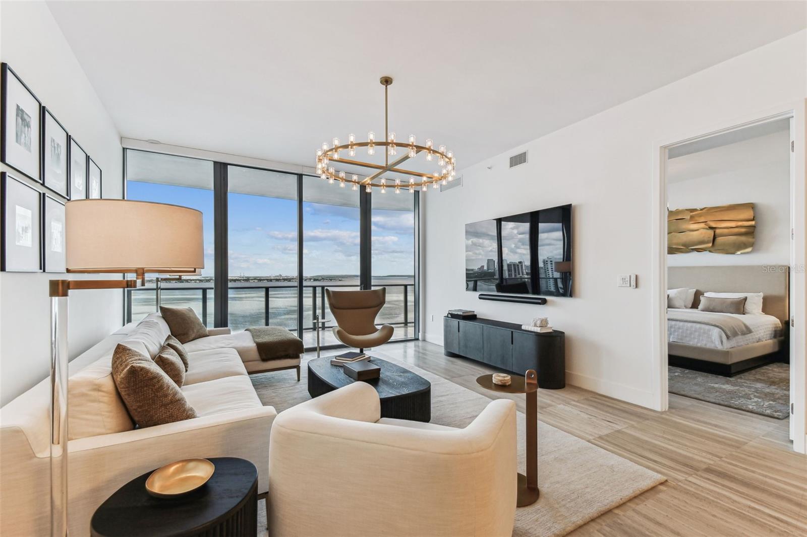 Offered designer furnished, this exceptional residence at the Ritz-Carlton Residences presents a rare opportunity to own one of Tampa's most prestigious waterfront addresses. Thoughtfully curated with a sophisticated yet relaxed aesthetic, every detail has been carefully selected to create a home that is both elegant and inviting.

Perfectly positioned along iconic Bayshore Boulevard, the residence captures sweeping views of Tampa Bay and the glittering downtown skyline. An expansive private balcony serves as an elegant extension of the living space, creating the perfect setting for morning coffee, sunset cocktails, or entertaining against a breathtaking waterfront backdrop.

Floor-to-ceiling glass fills the open-concept great room with natural light, while the chef's kitchen is beautifully appointed with premium appliances, quartz countertops, sleek custom cabinetry, and designer finishes. The luxurious primary suite is a private sanctuary featuring a spa-inspired bath and an extraordinary custom-designed walk-in closet that blends beauty with exceptional functionality.

Outside your door, miles of scenic waterfront along Bayshore Boulevard invite walking, jogging, and cycling, while Hyde Park Village, Downtown Tampa, Amalie Arena, the Straz Center for the Performing Arts, and some of the city's finest dining and entertainment destinations are just minutes away.

Ownership at the Ritz-Carlton Residences is defined by legendary service and exceptional amenities, including 24-hour concierge, complimentary valet parking, a resort-style pool, state-of-the-art fitness center, golf simulator, tennis courts, private wellness amenities, and the convenience of a daily continental breakfast.

This is more than a residence—it is an opportunity to own a beautifully furnished home where timeless design, impeccable service, and one of Tampa Bay's most coveted addresses come together.