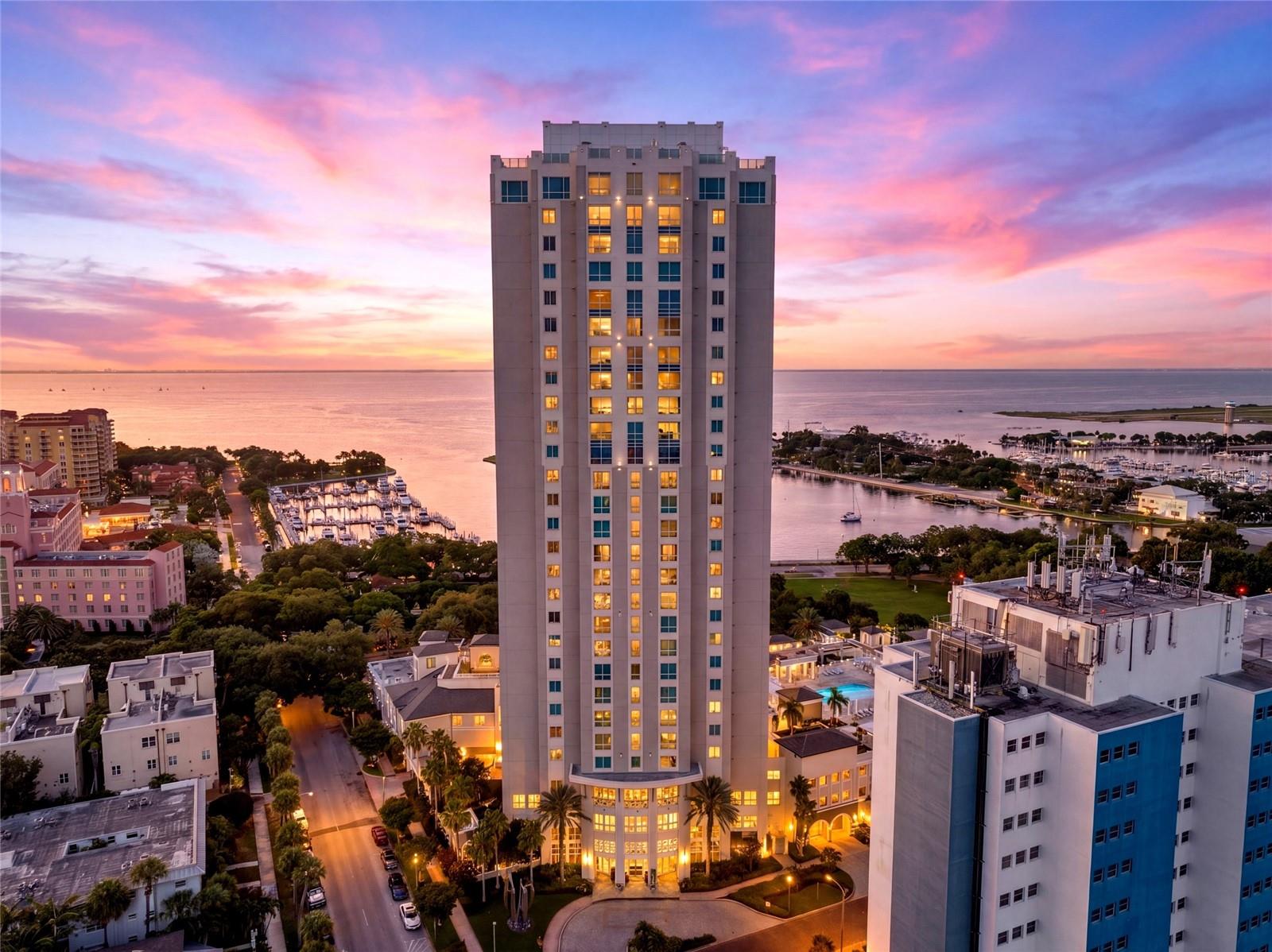 Trade view for value and enjoy the lowest entry point into ownership at the iconic 400 Beach; making luxury downtown living more attainable than ever before!  Experience resort-style luxury living in the heart of downtown St. Petersburg in this truly one-of-a-kind residence at the iconic 400 Beach Drive. Perfectly positioned ON THE HIGHLY COVETED 4TH FLOOR RESORT AMENITY LEVEL, WITH INFRARED SAUNA, FITNESS CENTER, SOCIAL ROOM AND OPPOSITE SIDE FROM THE POOL, this exceptional 2-bedroom + custom den/office, 2-bath residence offering 2,265 heated square feet combines privacy, convenience, and an unparalleled lifestyle. THIS FLOOR PLAN IS THE ONLY ONE IN THE BLDG WITH A FRONT BALCONY SPANING THE ENTIRE FRONT OF THE BLDG. TWO separate covered balconies—a highly sought-after feature! Enjoy peaceful mornings with coffee on the NE-facing balcony overlooking the charming Old NE + Vinoy Hotel, unwind in the evenings on the shaded west-facing balcony. 
The gourmet kitchen is beautifully appointed with GE Monogram stainless steel appliances, wine refrigeration, pull-out organizers, and lovely views of the historic Vinoy Resort and Old Northeast neighborhood.
Custom den/home OFFICE was thoughtfully DESIGNED BY RESPECTED ST. PETERSBURG WOODWORKER MICHAEL BRIGHT, creating a refined and functional workspace ideal for working from home, creative pursuits, or quiet retreat.

Primary suite includes custom ELFA closet systems and a Toto washlet, adding thoughtful luxury touches throughout.

Included: Two deeded secure interior garage parking spaces, a private EV charging station, and climate-controlled storage.

Residents of 400 Beach enjoy 365/24/7 concierge service, a resort-style heated pool/spa, a state-of-the-art fitness center, infrared saunas, a social room w/ billiards, guest conveniences, an active, luxury-lifestyle community.

DURING THE 2024 HURRICANES THAT IMPACTED TAMPA BAY, 400 BEACH PROVED TO BE A SECURE HAVEN FOR MANY RESIDENTS. Its solid construction, elevated design, and premier downtown location provided exceptional peace of mind during one of the region's most challenging storm seasons. For buyers considering Florida luxury living, the building's real-world performance during recent hurricanes offers an invaluable measure of resilience, security, and confidence.

THE OUTDOOR 4TH FLOOR IS ENTERING PHASE II OF ITS BEAUTIFULLY PLANNED ENHANCEMENT-FULLY PAID FOR BY CURRENT OWNERS, allowing the next owner to simply move in and enjoy the transformation. Planned improvements include LUSH TROPICAL LANDSCAPING, ELEGANT SHADE STRUCTURES, SHADED POOLSIDE SEATING, NEW OUTDOOR FURNISHINGS, INVITING CONVERSATIONAL GATHERING SPACES, and COZY FIREPIT LOUNGE AREAS thoughtfully designed to maximize Florida’s spectacular outdoor lifestyle year-round.
Located on Beach Drive NE, this premier address places you just steps from award-winning restaurants, sidewalk cafés, museums, theaters, waterfront parks, boutique shopping, the St. Pete Pier, Museum of Fine Arts, The Dalí Museum, and the vibrant energy of downtown St. Petersburg, while still enjoying the tranquility of the quieter north end of Beach Drive.

A rare opportunity to own a one-level luxury residence with private elevator access, exceptional walkability, resort amenities, and a truly unmatched lifestyle in one of downtown St. Petersburg’s most iconic addresses.