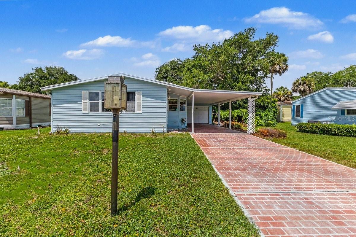 Welcome to 316 Portside Lane, located in the highly sought-after 55+ community of Edgewater Landing, one of Edgewater's most desirable active adult neighborhoods. Priced to sell and ready for your personal touches, this spacious home offers an incredible opportunity to create your dream Florida retreat while enjoying all the benefits of this award-winning riverfront community.

Featuring a spacious floor plan, attached garage, and covered carport, this home provides plenty of room for everyday living, entertaining, and storage. Major value has already been added with the $10,000 community assessment fully paid, giving buyers peace of mind and added savings. Whether you're looking for a year-round residence or seasonal getaway, this home offers tremendous potential at an attractive price point.

Edgewater Landing is a resident-owned community situated along approximately a mile of the Intracoastal Waterway, meaning you're just moments from breathtaking river views, fishing, boating, and spectacular sunsets. Residents enjoy an active lifestyle with amenities including a heated swimming pool, spa, clubhouse, fitness facilities, tennis and pickleball courts, bocce ball, shuffleboard, fishing pier, boat launch, boat and RV storage, walking trails, organized social activities, and 24-hour gated security. Best of all, you own your land—no lot rent!