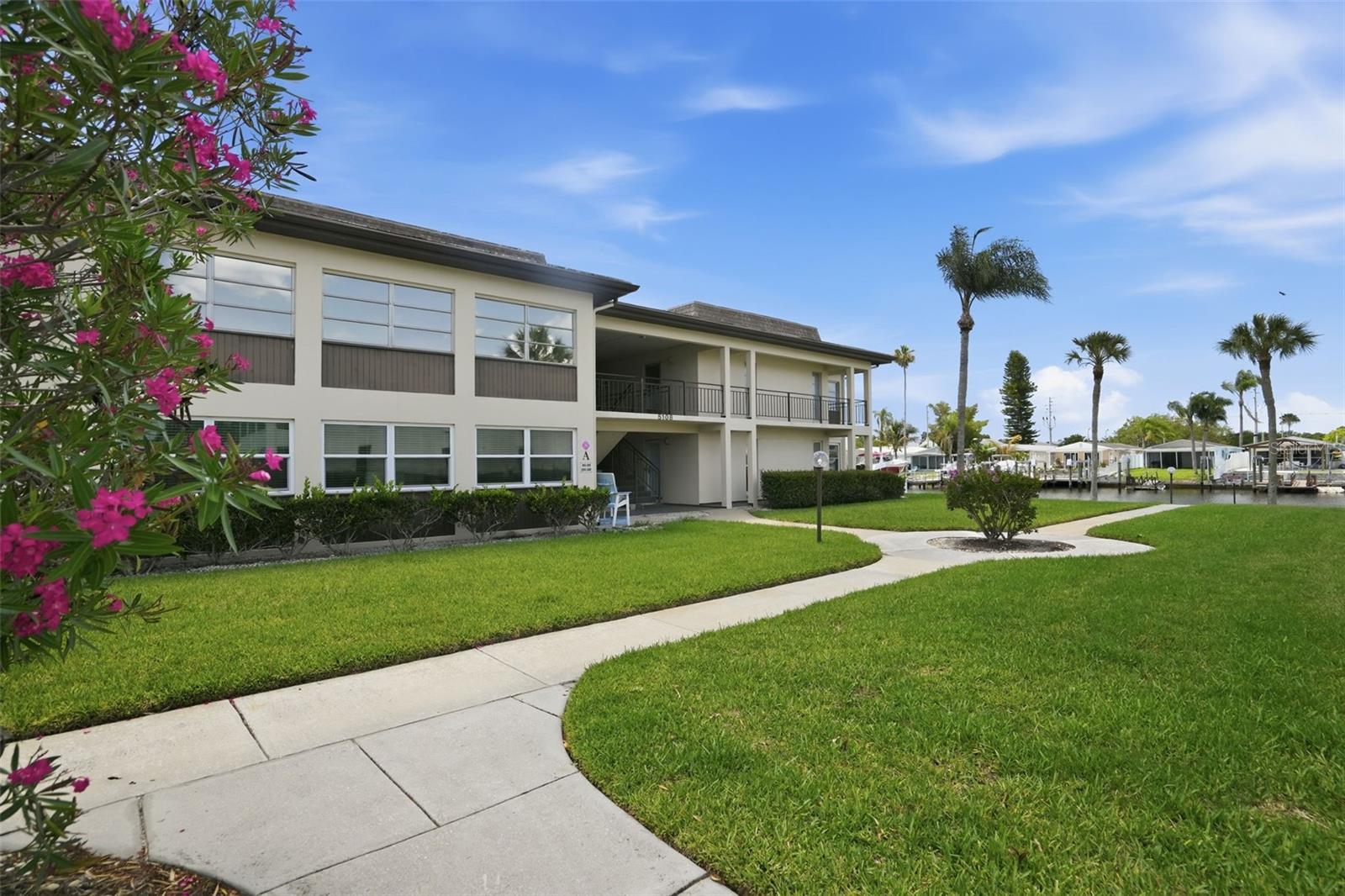This beautifully maintained 2-bedroom 2-bathroom second-floor condo located in the ALL AGES waterfront community of Gulf Harbors offers a perfect blend of comfort, convenience, and coastal charm.  Enjoy relaxing water and courtyard views from the spacious Florida room.  An open floor plan with living and dining combo can also be extended into the guest bedroom by a partitioned screen.  The guest bedroom is enhanced with a built-in Murphy bed, creating a flexible space for visitors or a home office.  The primary suite includes a walk-in closet and a private bath.  All rooms have sliding glass doors to access the Florida room and let in the natural light.  Gulf Harbors Condo residents enjoy access to community amenities, including a pool, clubhouse, shuffleboard, fishing, kayak storage, reserved carport, laundry room, and storage closet.  Condo fee includes cable, internet, water, trash, sewer, exterior maintenance and insurance (this unit did not flood!) Gulf Harbors Private Beach Club access for an additional yearly fee. AC instealled in 2020. Only service animals allowed. Rentals allowed after one year of ownership. All measurements approximate.
