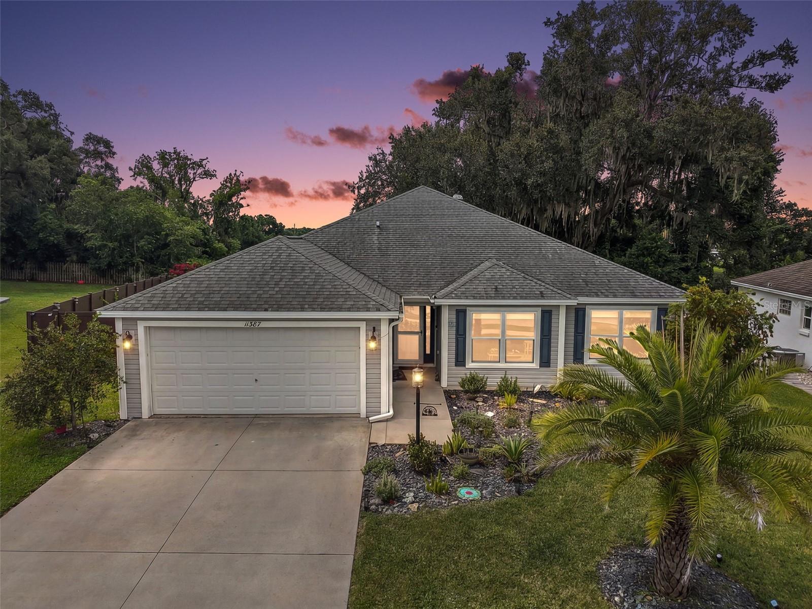 Welcome to this GORGEOUS 4-bedroom, 2-bath Ponderosa Pine model with OVERSIZED, EXTRA DEEP 528sf 2-CAR GARAGE, IN-LAW SUITE potential, EXPANSIVE GLASS-ENCLOSED LANAI with EXTENDED PVC PATIO, and PRIVATE FULLY-FENCED REAR YARD with ROOM FOR A POOL nestled within the VIBRANT, GATED community of Oxford Oaks! NO BOND! Conveniently located JUST MINUTES from The Villages Community and The Villages Charter Schools, as well as CR 466 with an ABUNDANCE of shops, restaurants, banks, medical, and more! Tropical landscaping in stoned beds and a side-lit entry welcome you in to the GENEROUS foyer. Soaring HIGH, VAULTED CEILINGS and an OPEN-CONCEPT layout of the living, dining, and kitchen create the perfect space for entertaining or relaxing. RICH, WOOD-GRAIN LUXURY VINYL PLANK flooring adds a sleek, modern touch and offers easy maintenance while TWO SOLAR TUBES bathe the home in NATURAL LIGHT. The STUNNING kitchen showcases crisp WHITE SHAKER cabinetry, neutral countertops, hexagon TILE backsplash, STAINLESS appliances, built-in DOUBLE PANTRY, and an EAT-IN counter for casual dining. An adjacent dinette features VAULTED ceilings and a BAY WINDOW. From the living room, step through TRIPLE SLIDING GLASS DOORS into the EXPANSIVE 27’x12’ GLASS-ENCLOSED LANAI with extended 16’x20’ PVC PATIO. Whether sipping your morning coffee, hosting a weekend barbecue, or unwinding after a long day, this FABULOUS space offers plenty of space for lounging, dining, and year-round entertaining all within a PRIVATE, LARGE, FULLY-FENCED YARD with ROOM FOR A FUTURE POOL! Back inside, the primary bedroom features a VAULTED ceiling, TWO windows, and a GENEROUS WALK-IN CLOSET. Its STYLISH en-suite bathroom features WHITE SHAKER cabinetry, DUAL sinks, a TILED ROMAN-STYLE WALK-IN shower, LINEN closet, and a separate water closet. Near the front of the home, two additional bedrooms and a second bath are conveniently located behind a POCKET DOOR, creating a potential in-law suite or PRIVATE guest wing. Both bedrooms offer WALK-IN closets and the second bathroom features a WHITE SHAKER vanity, TILED tub and shower combination, and a hallway LINEN closet. There’s also a fourth bedroom located just off of the dining room with DOUBLE windows and a built in closet. This wonderful room can double as either a home office or an additional sleeping area. A centrally-located INTERIOR laundry room, hidden behind a POCKET DOOR near the garage, features a built-in utility sink and additional WHITE SHAKER cabinets for extra storage needs. Completing the package is an EXTRA-DEEP 30’x20’ TWO-CAR GARAGE with EPOXIED floor, EV charger, and plenty of space for vehicles, bikes, and toys! Additional UPGRADES include UPDATED APPLIANCES, and SOLAR PANELS that provide energy-efficiency and savings! DON'T MISS YOUR OPPORTUNITY to make this INCREDIBLE HOME YOUR OWN! Oxford Oaks is a non-age-restricted, golf cart friendly GATED community built by The Villages. EXCLUSIVE AMENITIES INCLUDE: a large resort-style pool with a spacious pavilion, pickleball courts, tennis courts, basketball court, outdoor exercise equipment, and a fabulous playground! Also close by are Lake Sumter Landing and Brownwood Paddock Squares in The Villages offering various shopping and dining options, a movie theater, and live nightly entertainment! PLEASE WATCH OUR WALKTHROUGH VIDEO OF THIS AMAZING HOME and call today to schedule your Private Showing or Virtual Tour!