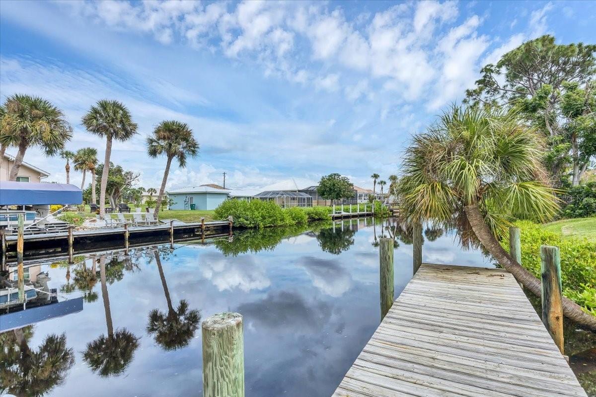 Nestled on a desireable saltwater canal on the Coral Ceek watershed, with just one large bridge to the Gulf. This beautifully updated home offers the perfect blend of coastal charm and everyday convenience. Ideally located only a block to Publix, the post office and a nearby convenience sore, the home also enjoys close proximity to the area beaches, popular restaurants, and local schools. Recent upgrades include a spacioius screened lanai where you can relax and enjoy peacful water views. Boating enghusisasts will appreciated the dock equipped with a 7000 pound boat lift, making it easy to head out for a day on the water. Whether you are looking for a full time residence or perfect coastal retreat, this property delivers the best of waterfront living with exceptional accessibility and modern updates.