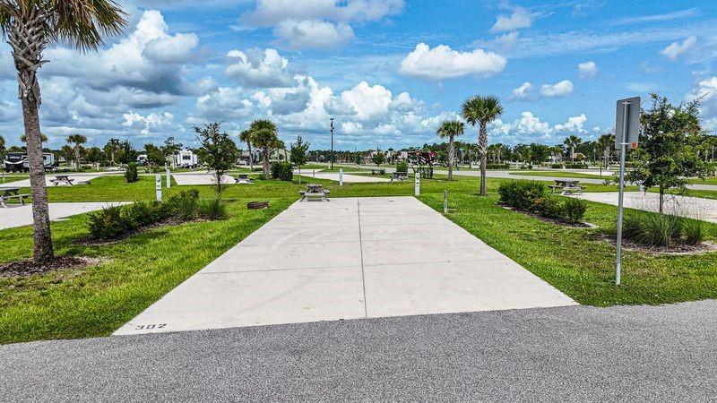 Discover an exceptional opportunity to own a slice of luxury in one of Central Florida’s most sought-after RV resorts at Resort at Canopy Oaks. Whether you're seeking a refined personal retreat or a professionally managed income-producing property, this rare deeded 45’ x 90’ RV lot offers the best of both worlds. Lot 302 is centrally located within the resort and features a fire ring and picnic table, making it perfect for relaxing outdoors. The site is ready for your RV and offers flexibility to customize the space to suit your preferences and style. The generous 20’ x 70’ concrete pad features full hookups (20/30/50 amp) and easily accommodates Class A, Class C, fifth wheels, travel trailers, or even a small park model—making it the perfect carefree seasonal retreat. Located within a breathtaking 435-acre gated retreat, ownership includes full access to an impressive collection of amenities. Enjoy a tropical tiki bar, sparkling pool and hot tub, pickleball courts, a state-of-the-art fitness center, full-service spa, and convenient on-site dining — all thoughtfully designed to deliver an elevated, luxury lifestyle experience. Enjoy elevated resort living on your terms — with the flexibility to generate rental income when you’re away. **Developer incentives are currently available, adding even more appeal to this remarkable opportunity!**
