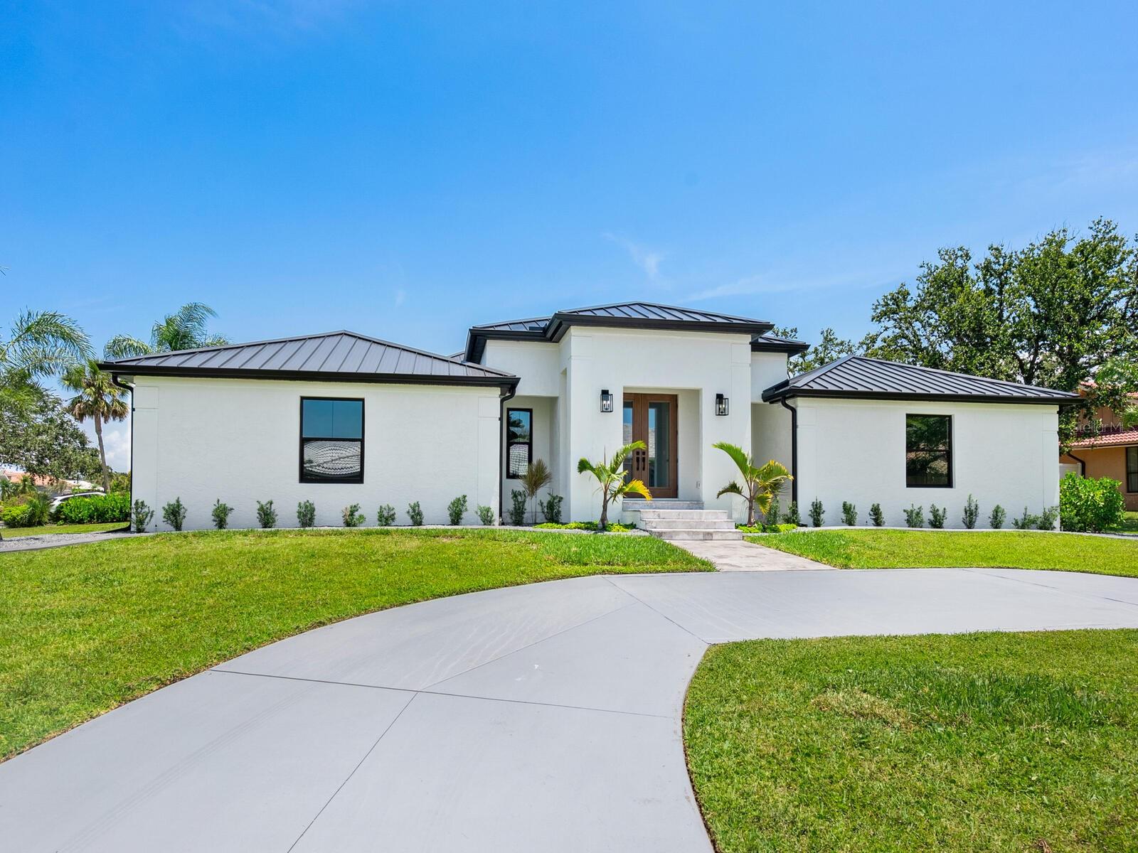 One or more photo(s) has been virtually staged. Welcome to 180 Lookout Point Drive in the sought-after Southbay Yacht & Racquet Club with deep water marina and available boat slips, the opportunity to walk to your boat in a deep water marina with your home resting safely in Flood Zone X (where flood insurance is not even required by lenders) doesn't come along often. This is an extraordinary residence taken fully down to the studs and reimagined as a like-new, luxury smart home. Set on a .4-acre lot in Flood Zone X (no lender-required flood insurance), this never-lived-in five-bedroom, 3.5 bath, 3,236-square-foot home blends solid block construction with high-end design and cutting-edge technology. No detail was overlooked, including a standing seam metal roof, all new high-velocity impact windows, hurricane-rated garage doors and fully integrated Alexa features throughout. Wide-plank wood floors lead through a thoughtfully designed layout featuring custom built-ins including a kitchen desk, mudroom storage, dining room bar with wine refrigerator and living room shelving with glass doors. The kitchen is a showstopper with two large quartz islands, top-of-the-line Thermador appliances, a microwave drawer, concealed refrigerator, gas range with double ovens and a custom glass-door butler’s pantry. French doors at the entry feature Alexa-controlled electronic glass for your choice of instant privacy or transparent green views, while oversized sliders in the main living area fully retract for seamless indoor-outdoor living. The massive laundry room is a dream with two washers, two dryers, abundant storage and countertop space. Outside, enjoy a stunning new saltwater pool with cage, paver decking, and a state-of-the-art outdoor kitchen including storage and pullout drawer refrigerators, ideal for entertaining. The oversized garage offers excellent storage and the home’s elevation offers added peace of mind. Southbay is one of Sarasota County’s desirable waterfront communities with an updated clubhouse and fitness center overlooking the bay, complete with a ballroom, catering kitchen, meeting room and library. Community amenities also include a geothermal heated pool, children’s pool, tennis, pickleball, shuffleboard, basketball, kayak storage and a seven-acre deep-water marina accommodating boats up to 55 feet. Residents enjoy 20 acres of lush common grounds and five miles of walking trails, plus a vibrant calendar of social events. Near SR 681, with easy access to downtown Sarasota, Venice, beautiful beaches and A-rated schools including Laurel Nokomis, Sarasota Middle, Venice High, Pine View and the European Academy. This is a rare opportunity to own a turnkey, top-tier home in an unmatched boating community.
