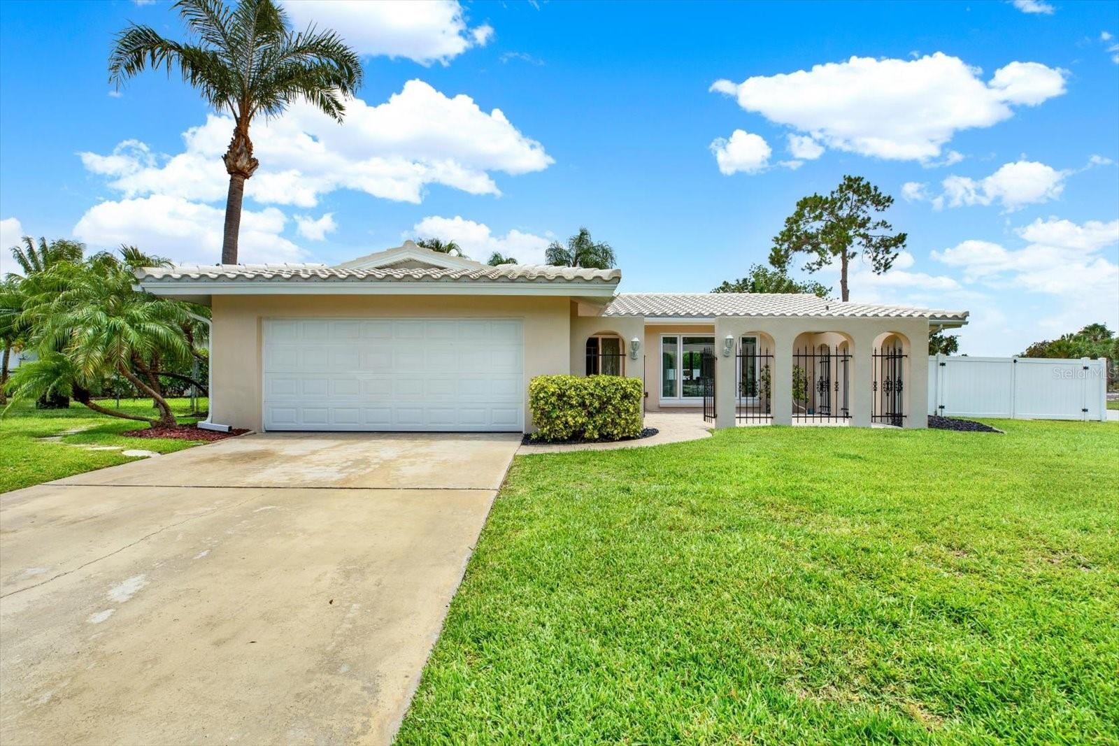 Welcome to this beautifully maintained 3-bedroom, 2-bath pool home situated on an oversized corner lot spanning more than a quarter acre in the highly sought-after Imperial Point community. From the moment you arrive, you’ll be captivated by the freshly painted exterior, bright white tile roof (just 12 years old), and lush, manicured landscaping enhanced by a full irrigation system.
A charming gated courtyard with elegant paver accents creates a warm and inviting entrance, setting the tone for the exceptional living experience that awaits inside. The thoughtfully designed split-bedroom floor plan offers both privacy and functionality, while two spacious living areas—a formal living room and a separate family room—provide plenty of space for entertaining, relaxing, and everyday living.
The interior features ceramic tile flooring, freshly cleaned carpeting, and an indoor laundry room for added convenience. Every space has been carefully maintained, creating a move-in-ready home you’ll enjoy from day one.  Step outside to your private backyard oasis, where a sparkling in-ground pool serves as the centerpiece of outdoor living. Adjacent to the pool, a covered and screened patio with attractive paver flooring provides the perfect shaded space for outdoor dining, relaxing, or hosting guests throughout the year. Beyond the pool area, the expansive backyard offers an abundance of green space rarely found with pool homes, creating endless possibilities for a playground, fire pit, garden, pets, or simply enjoying your own private retreat. A large storage shed located in the side yard provides additional space for tools, equipment, and outdoor essentials.

Major updates provide valuable peace of mind, including a brand-new A/C system backed by a 12-year transferable warranty. For boat owners, this property offers a rare advantage with double-gate access leading to dedicated concrete trailer pads, providing secure and convenient storage right on your property.
Living in Imperial Point means enjoying one of Pinellas County’s most amenity-rich waterfront communities. Residents have access to a beautiful clubhouse situated directly on the Intracoastal Waterway, featuring a fitness center, library, game room, billiard room, and full kitchen. The community hosts a variety of social events and activities throughout the year, creating an active and welcoming neighborhood atmosphere. You’ll also enjoy an Olympic-size waterfront pool, fishing dock, boat ramp, playground, shuffleboard courts, pickleball courts, and tennis courts—all designed to help you make the most of Florida’s outdoor lifestyle.
This home has experienced no flooding during recent hurricanes, highlighting its favorable elevation and desirable location.
Combining a generous lot, private pool, abundant outdoor space, practical storage solutions, exceptional community amenities, and the coveted Imperial Point location, this exceptional property presents a rare opportunity to enjoy the Florida lifestyle without compromise. Homes with this combination in Imperial Point do not last long. Schedule your private showing today and discover everything this remarkable home has to offer.