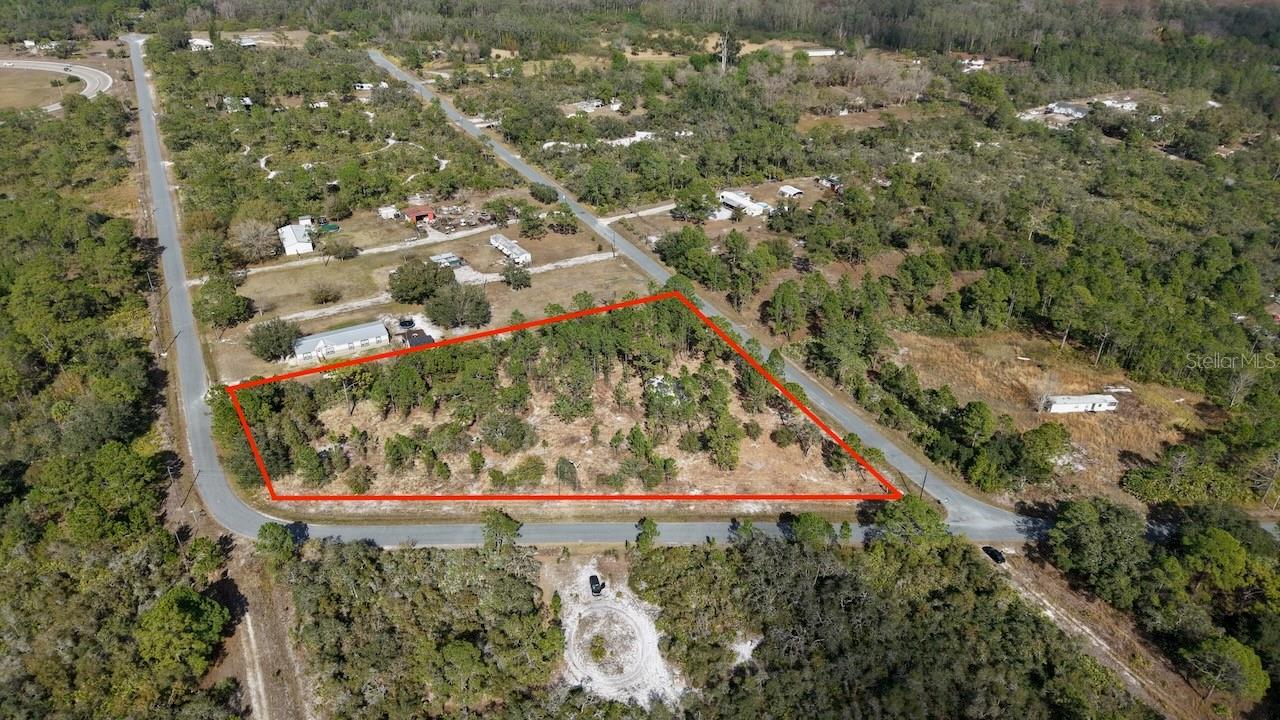 Back on market* High and dry 2.10-acre homesite combining privacy, usable acreage, and proximity to SR-60 and the Florida Turnpike. Recently scrub-brushed, making the property easier to walk and evaluate. Quiet rural setting with nearby established homes and larger acreage parcels, providing separation without isolation. Zoned AG for single-family or manufactured home use with well and septic required. Just minutes from SR-60 and the Florida Turnpike, allowing convenient travel to Okeechobee, Yeehaw Junction, and surrounding areas. Close to Lake Okeechobee recreational opportunities while maintaining a private, residential feel. Suitable for a primary residence, manufactured home placement, or long-term land hold. Lot lines approximate. * legacy code enforcement issues now resolved.