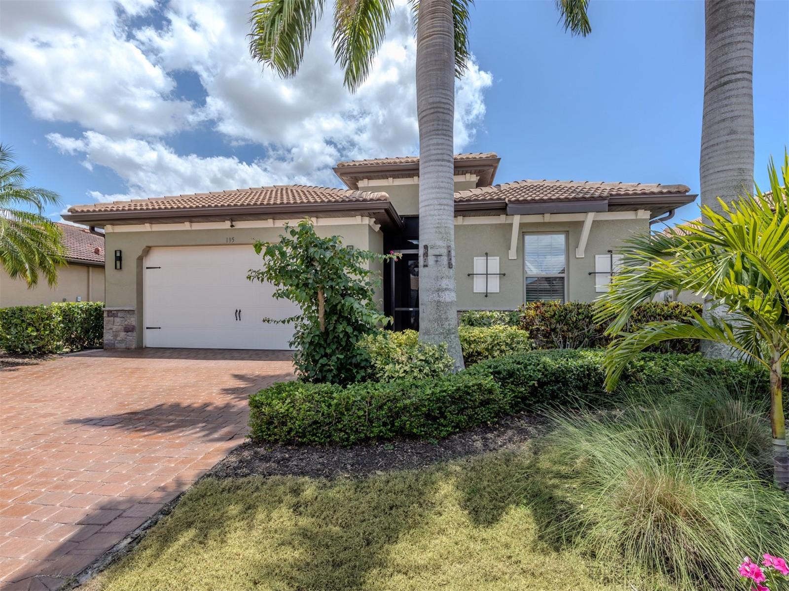 Experience the sought-after resort lifestyle of Toscana Isles in this beautifully upgraded residence designed for effortless indoor-outdoor living. Ideally positioned within one of the area’s premier gated communities, this exceptional home combines elevated finishes, smart functionality and inviting outdoor spaces perfect for enjoying the Florida lifestyle. Inside, elegant designer details are found throughout, including plantation shutters, LED lighting and a striking custom stone accent wall that anchors the great room. The beautifully appointed kitchen features quartz countertops, cabinet lighting, Samsung stainless steel appliances and a double oven, creating a stylish and functional space for entertaining and everyday living. The spacious primary suite offers added comfort with power shutters, while both baths have been tastefully updated with custom porcelain tile, LED lighting and quartz surfaces in the primary bath. Additional enhancements include electric Storm Smart hurricane shutters, whole-house water filtration, wiring for a generator capable of powering the home excluding the aire conditioner during outages and exterior Lutron LED lighting. Designed to embrace outdoor living, the travertine lanai features an outdoor sink and cabinetry, while the expansive paver patio showcases custom built-in seating with power access, a wood-burning fire pit and a grill station, ideal for relaxing or entertaining under the stars. The garage is equally impressive, with a Gorilla garage floor system and custom shelving for exceptional organization and storage. Toscana Isles delivers resort-style living. Enjoy over 200 acres of lakes ideal for kayaking, paddleboarding, fishing and more. The Tuscan-inspired clubhouse features an infinity pool, a fitness center, billiards, a bar and event spaces. Outdoors, residents love tennis, bocce, a dog park and one of the area’s active pickleball programs. All this is just two miles from Sarasota Memorial Hospital, six miles from Nokomis Beach and minutes to Venice Island’s shops, dining and world-class Gulf sunsets.