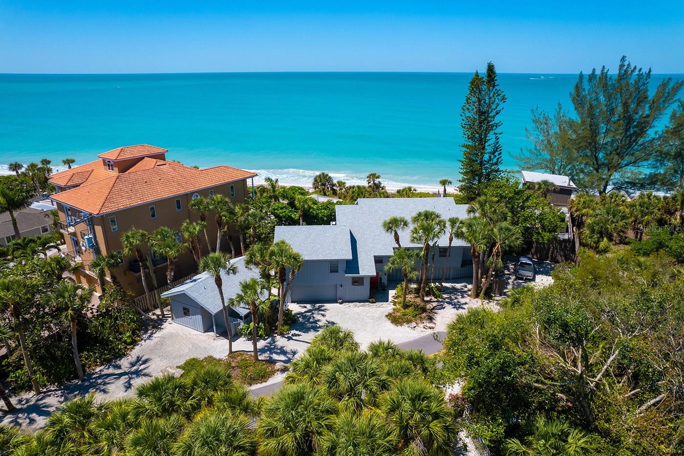 New price! An exceptional opportunity for this Gulf front, elevated home on the desirable shores of Casey Key. This quintessential beachfront retreat, Osmyrrah, is a sanctuary of tranquility, designed for relaxed, organic living with an intimate connection to the sea. With private, pristine beachfront and panoramic Gulf views, you’ll be immersed in dazzling sunsets, soft white sands and the soothing rhythm of the waves every single day. Savor nature’s splendor in nearly 3,000 square feet of elevated living space, where an open-concept layout, soaring ceilings and walls of glass bring the outside in. The expansive great room and dining area seamlessly flow into a generous kitchen with panoramic Gulf views, ideal for entertaining or pensive mornings. Go onto the open deck for grilling and sunning or unwind on the large screened-in porch while warm breezes and golden skies set the mood. The gulf-front primary suite is a private oasis with lofty ceilings, stunning water views, a luxurious renovated bath and a spacious walk-in closet. A guest bedroom, full bath and dedicated office complete the north wing. On the south side, you’ll find a second large primary suite with its bath and walk-in closet, along with a full laundry room. Guests will delight in their own charming 360-square-foot guest house, complete with a private entrance, high ceilings, living area and full bath, near the beach and a refreshing outdoor shower. Additional highlights include a two-car garage, new HVAC (2025), roof (2019) and an expansive under-home storage area, ideal for kayaks, paddleboards and all your coastal toys. A private walkway leads to your beachfront deck and down to the sand, offering an experience akin to a Caribbean island escape. The property also includes a three-foot deeded bay access easement and a reciprocal beach access easement for the bayside neighbor. On this serene 8-mile barrier island of fewer than 400 homes, you’ll enjoy rare privacy, natural beauty and Gulf ownership to the mean high-water line. South of the iconic Blackburn Point swing bridge, you’re just minutes from golf, dining, shopping, top-rated schools - including nationally acclaimed Pine View School - and vibrant cultural destinations in Sarasota and Venice. If you’ve dreamed of living where sunsets paint the sky, dolphins dance at dawn and every day ends with your toes in the sand, Osmyrrah awaits.