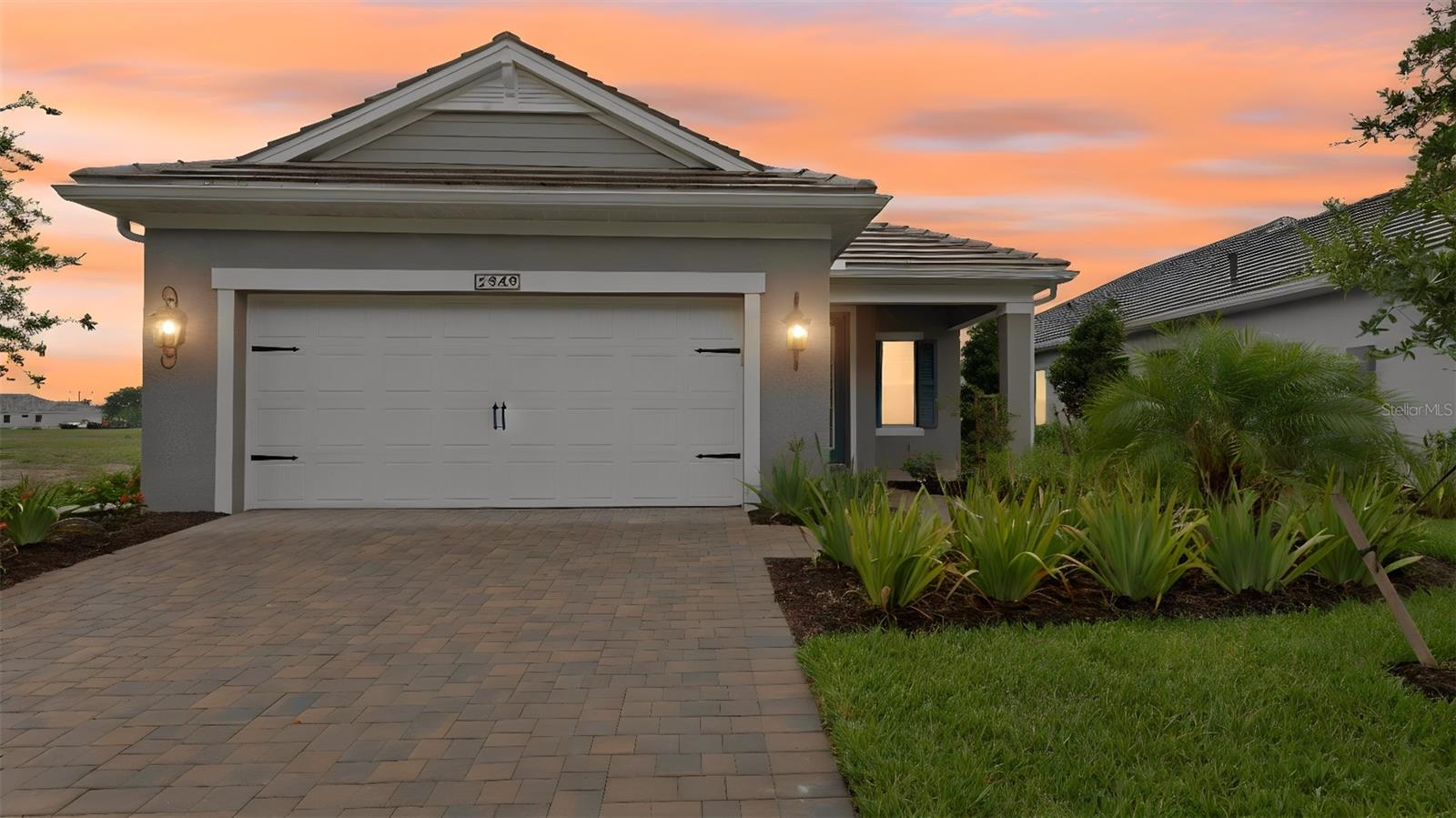 Some communities have amenities. Verandah has a LIFESTYLE. There's a difference, and you'll feel it the moment you arrive.
Nestled along the Orange River in Fort Myers, Verandah is a GATED community where 36 holes of CHAMPIONSHIP GOLF — designed by Jack Nicklaus and Bob Cupp — set the tone for everything else. Waterfront dining, pickleball, tennis, kayaking, a RESORT POOL, spa, fitness center, and a social scene that runs YEAR-ROUND make it easy to fill your days exactly the way you want. Mornings on the course. Afternoons by the pool. Evenings at the River House. It has a nice ring to it. Now imagine coming home to this. The Dream 2 floor plan in Heritage Preserve  was THOUGHTFULLY UPGRADED from the ground up. The Coastal C-2 elevation arrives with WHOLE-HOUSE IMPACT GLASS — no storm panels, no compromises — and a paver driveway in tan and charcoal that sets the tone before you even reach the door. Inside, 1,860 square feet of living space flows the way a Florida home should. EIGHT-FOOT DOORS throughout. Wood-look tile in the main living areas and cozy carpet in all three bedrooms. The Great Room opens wide with a RECESSED CEILING, and POCKET SLIDERS disappear into the wall to let the lanai become part of the conversation. The kitchen was designed to IMPRESS. White Korbett cabinetry with crown molding, SOFT-CLOSE DOVETAIL DRAWERS, roll-out shelves, and a one-level island dressed in BIANCO DOLOMITE QUARTZ. A vertical picket tile backsplash, GE SLIDE-IN GAS RANGE with air fry, exterior-vented microwave, French door refrigerator, and UNDER-CABINET LED LIGHTING round out a kitchen that's as functional as it is beautiful. The den features GLASS FRENCH DOORS and its own wall-mount TV outlet — flex space that works as a home office, media room, or quiet retreat. The primary suite is finished with four RECESSED LIGHTS and a SPA-CALIBRATED BATH: dual Moen Gibson widespread faucets, quartz counters, WALK-IN SHOWER with floor-to-ceiling 12x24 tile, BRUSHED NICKEL hardware, and a tiled shower niche. The OUTDOOR KITCHEN ROUGH-IN, POOL PRE-WIRE, and EXTENDED 2-CAR GARAGE make the next chapter easy to write.
If the Florida golf lifestyle is what you've been working toward, this is a home — and a community — that DELIVERS on that promise.