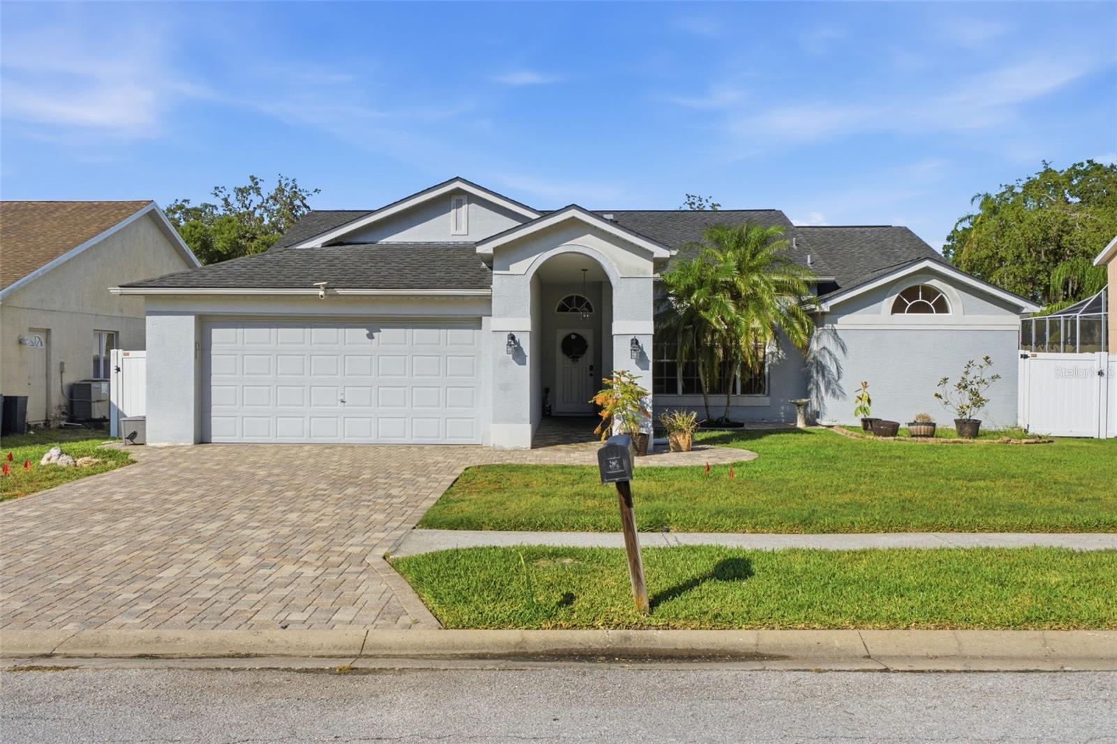 Welcome home to 10050 Hermosillo Drive; your own slice of Florida paradise right here in Southern Oaks!  This beautiful pool home offers 3 bedrooms, 2 bathrooms, and an  2-car garage with plenty of room for storage, hobbies, or all your Florida toys. With 1,814 sq. ft. of living space and a fantastic location near everything in New Port Richey and Trinity, this home truly has it all. Step inside and you’ll immediately notice the bright, open floor plan with soaring cathedral ceilings throughout the main living areas and vaulted ceilings in the bedrooms, creating a spacious and airy feel. The kitchen boasts newer appliances and the washer and dryer are included. The desirable split-bedroom layout offers privacy and comfort, featuring a generous primary suite with dual sinks, a relaxing garden tub, separate shower, and walk-in closet. The heart of the home is the open kitchen overlooking the family room, pool, and lanai, perfect for entertaining family and friends or simply enjoying peaceful poolside views every day. Just off the pool area, you’ll also find an additional leisure/family room that can easily become a game room, home office, fitness space, or cozy retreat. Outside is where Florida living really shines! The screened-in pool and covered lanai create the perfect year-round outdoor oasis, complete with a paved patio for relaxing or hosting gatherings. The fully fenced backyard adds privacy and plenty of room for pets or play. This home is also loaded with smart features and security upgrades, including a monitored Ring alarm system (security, fire, cameras), Ecobee thermostat with remote sensors, smart light switches and fan controls, smart irrigation system, and water leak sensors throughout (compatible with all smart home systems). Additional highlights include newer wood-look tile flooring in the main living areas, LVP and tile flooring in the master suite, freshly sealed paver driveway and patio, inside laundry room with utility sink This well-loved home is move-in ready and waiting for its next owners to start making memories. Schedule your private tour today!