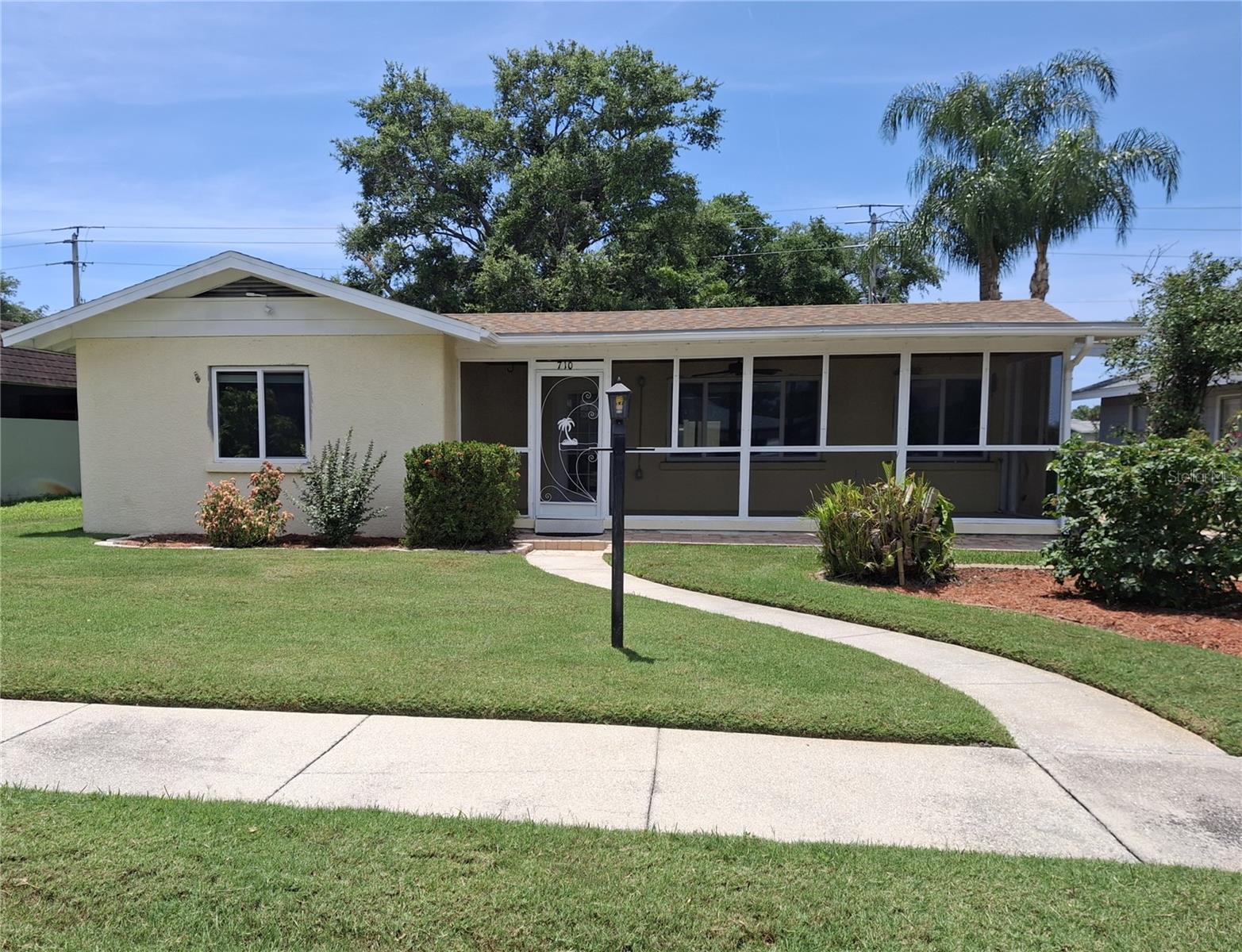 This beautiful large home with old Florida charm is nestled in the Bradenton Country Club neighborhood.  The large palm tree lined street of well maintained older homes is located near Manatee Avenue.  GT Bray park is nearby as well as shopping, medical facilities and restaurants.  If you like the beach, you are just minutes from Holmes Beach!  The back yard is fenced with a patio. The carport is large with parking west of the fence.  This well-built home is a must see!  The home has all new windows, newer roof and A/C.  The kitchen quartz counter tops are new and the wood cupboards are original. The large master bedroom and bath have been updated.  The bedrooms are larger than most newer homes, the front porch is spacious and the home has a lot of storage as well as inside laundry room. The skylight brightens the guest bath off the hall.   The irrigation system ensures a beautiful green lawn.  Few homes are listed in this neighborhood.  The rose arbor on the right side of the home leads to back yard.  The mango tree in the front yard is bearing and is usually loaded during season!  Sold As-Is.  Garden hose does not convey.  Ceiling fan in front living room is not connected.