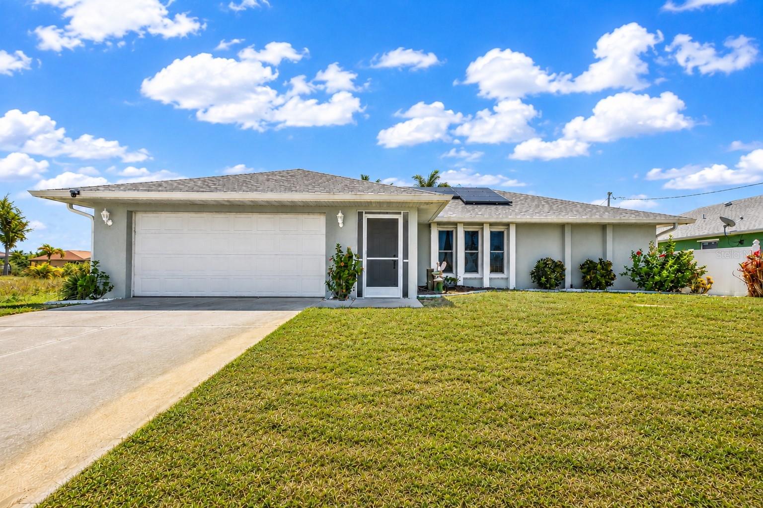 Affordable Gulf access waterfront pool home with dock and 10,000 lb boat lift located in the desirable waterfront community of South Gulf Cove. This well-maintained home offers the perfect opportunity for full-time living, a seasonal retreat, or an income-producing short- or long-term rental property, and comes fully furnished for an easy move-in experience. Recent updates provide peace of mind, including a NEW ROOF (2021), water heater (2024), replacement windows with hurricane protection shutters (2013), dock and boat lift (2015), and solar panels installed in 2022 to help keep electric bills low. Inside, the clean and bright split-bedroom floor plan features vaulted ceilings, an open feel throughout, and NO CARPET flooring for easy maintenance. The extra family room, dining room and the spacious primary suite open directly onto the covered lanai, creating a seamless indoor/outdoor living experience. Outside, enjoy the waterfront setting with a private pool, boating access, and a 10x14 shed providing plenty of extra storage space for tools, fishing gear, pool equipment, or outdoor toys. South Gulf Cove offers public water and sewer, NO CDD fees, and an optional HOA. Conveniently located near boating, fishing, golf, shopping, dining, beaches, and more.