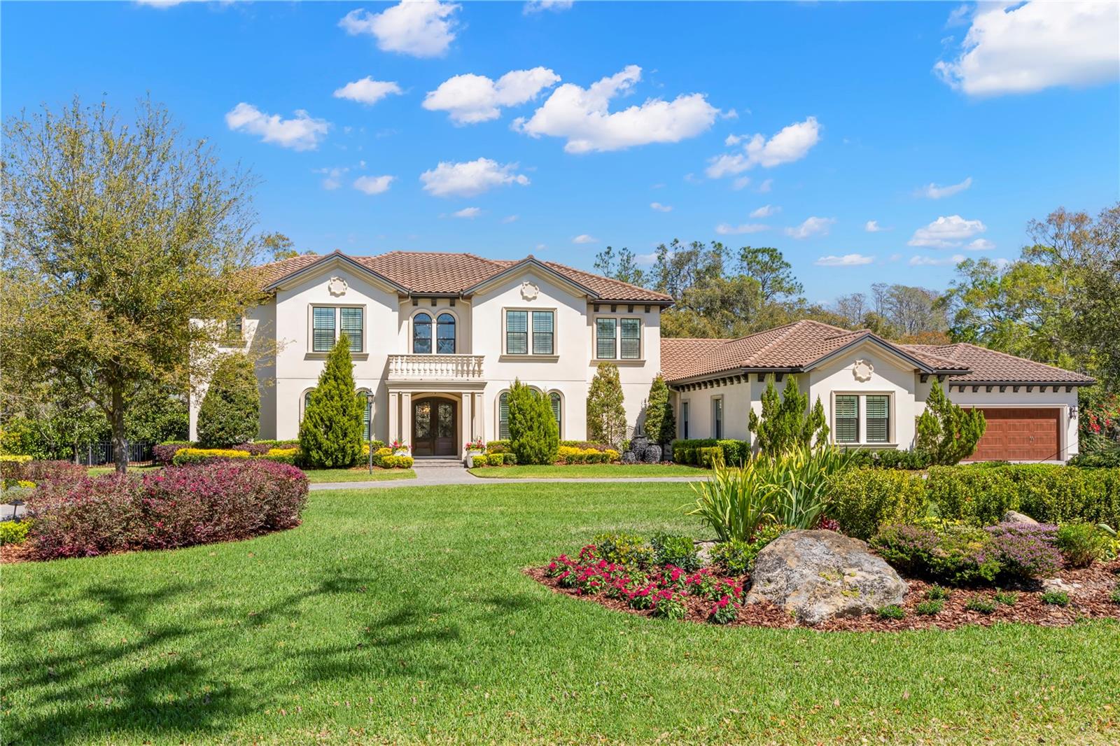 Experience unparalleled luxury and modern convenience in this breathtaking 6,454 sqft Mediterranean-style estate, built in 2020 by a premier high-end builder. Situated on over an acre of pristine lakefront property, this meticulously designed home offers a seamless blend of sophistication, comfort, and cutting-edge technology. As you step inside, a grand two-story entrance welcomes you with soaring ceilings and a striking spiral staircase, setting the tone for the elegance that flows throughout the home. The expansive floor plan features six bedrooms and six and a half bathrooms, with impeccable craftsmanship in every detail. A unique feature of this estate is the flexibility to choose the location of the primary bedroom, with an option on both the first and second floors, allowing the new owner to customize their living experience. The gourmet kitchen is a showstopper, boasting a premium JennAir appliance package, a massive island, wall-in pantry, additional butler’s pantry, coffee bar, all with custom cabinetry and designer finishes. The open-concept layout flows effortlessly into the spacious living and dining areas, perfect for intimate gatherings and grand entertaining. For those who work from home, the property offers two offices, including one with a private entry for added convenience. A state-of-the-art media room and a fully equipped gym ensure that entertainment and wellness are always within reach. A Savant Smart Home Automation System, the industry leader in home control, elevates the home's modern appeal. This cutting-edge technology provides seamless lighting, entertainment, audio, climate, and security management, all at your fingertips—whether at home or away. Step outside to your private resort-style retreat, where a sprawling lanai, full outdoor kitchen, and luxurious saltwater pool with a hot tub create the ultimate space for relaxation and entertaining. With breathtaking lake views as your backdrop, every moment spent outdoors is truly memorable. Additional features include a 4-car garage, a whole-home generator for uninterrupted comfort, and the finest high-end finishes throughout. This extraordinary estate presents a rare opportunity to own a lakefront sanctuary that exudes elegance, innovation, and unparalleled luxury.