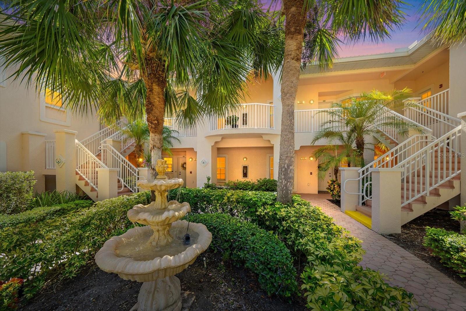 Virtually Staged. Located within the gated Plaza De Flores community, this ground floor corner condominium offers 2 bedrooms, 2 bathrooms, and 1,156 square feet with a split-bedroom floor plan designed for privacy and functionality. Concrete construction between floors with block party walls, high ceilings, and an abundance of natural light create a comfortable living environment, while the screened oversized lanai overlooks mature landscaping and includes additional privacy shades for year-round enjoyment. The kitchen features ample cabinet and countertop space and opens seamlessly to the dining and living areas, providing an efficient layout for everyday living and entertaining. The primary suite offers private lanai access, dual walk-in closets, and an en-suite bathroom with dual sinks and a walk-in shower. The guest bedroom and adjacent full bathroom provide flexible space for guests, a home office, or additional living needs. Maintained in its original condition, this residence presents an opportunity for the next owner to renovate and personalize the interior to suit their preferences. Recent community improvements include a brand-new roof, updated paving, and new carports completed between 2023 and 2025, with all assessments paid. Plaza De Flores residents enjoy a gated entrance, clubhouse, heated pool and spa, fitness center, tennis court, and beautifully landscaped grounds. Conveniently located near shopping, dining, The Legacy Trail, Siesta Key Beach, downtown Sarasota, and Interstate I-75, this property offers easy access to many of the area's most sought-after destinations.