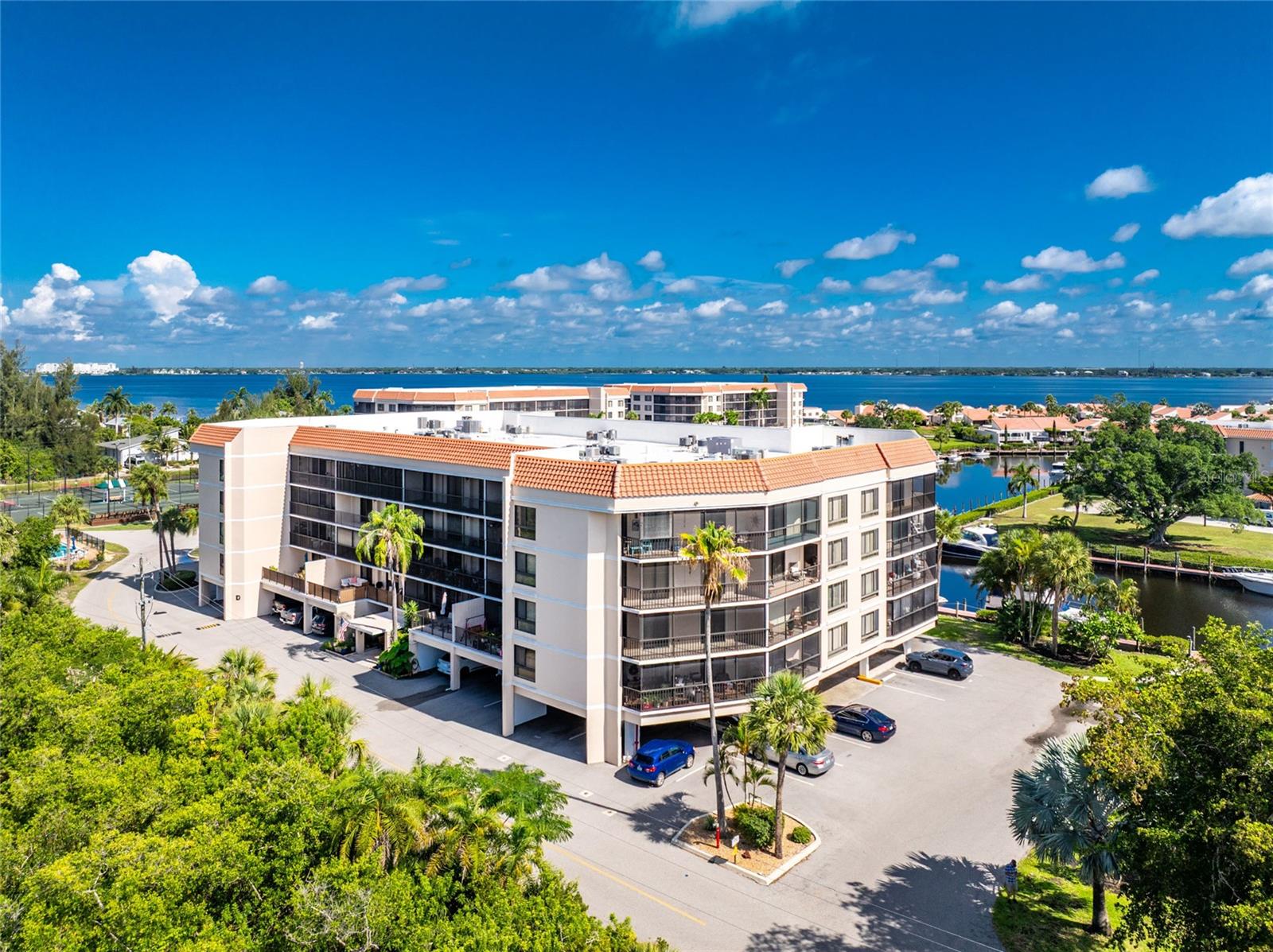 Experience waterfront living at its finest in this rarely available corner-unit condo in the highly sought-after Emerald Pointe community. Offering 1,912 square feet of beautifully updated living space, this spacious 2-bedroom, 2-bathroom residence with a den (featuring a closet and easily functioning as a third bedroom) is ideally located just minutes from Charlotte Harbor with direct access to the Gulf of Mexico. A boater's dream, the community offers dock assignments and dry boat storage right in your backyard—both included in the HOA fees. Beautifully remodeled from top to bottom, this exceptional home showcases an open-concept floor plan with raised ceilings, luxury flooring throughout, and a stunning chef's kitchen featuring quartz countertops, a large center island, premium stainless steel appliances, an induction cooktop, and an under-counter microwave. The oversized primary suite offers walk-in closets, private access to the wraparound lanai, and a luxurious ensuite bathroom with dual vanities, a spacious walk-in shower, and a relaxing soaking tub. The guest bedroom also features sliding glass doors leading directly to the lanai, while the versatile den includes a closet, making it ideal as a home office, media room, or third bedroom. Sliding glass doors from the great room, primary suite, and guest bedroom fill the home with natural light and seamlessly connect the interior to the expansive wraparound screened lanai—perfect for relaxing or entertaining while enjoying Florida's year-round sunshine. Emerald Pointe offers an outstanding resort-style lifestyle with amenities including a private marina, clubhouse, seasonal waterfront restaurant, fitness center, tennis courts, pickleball courts, three swimming pools, and a vibrant social calendar with numerous clubs and activities. Located just a short walk or bike ride from historic downtown Punta Gorda, you'll enjoy waterfront parks, scenic walking and biking trails, boutique shopping, exceptional dining, farmers markets, art festivals, and year-round community events. Spend your days boating to waterfront restaurants, including the iconic Fisherman's Village, or take advantage of convenient direct flights from nearby Punta Gorda Airport via Allegiant Airlines. With the luxury Sunseeker Resort just across the bridge, this move-in-ready waterfront condo offers the perfect combination of luxury, convenience, boating access, and the Southwest Florida lifestyle.