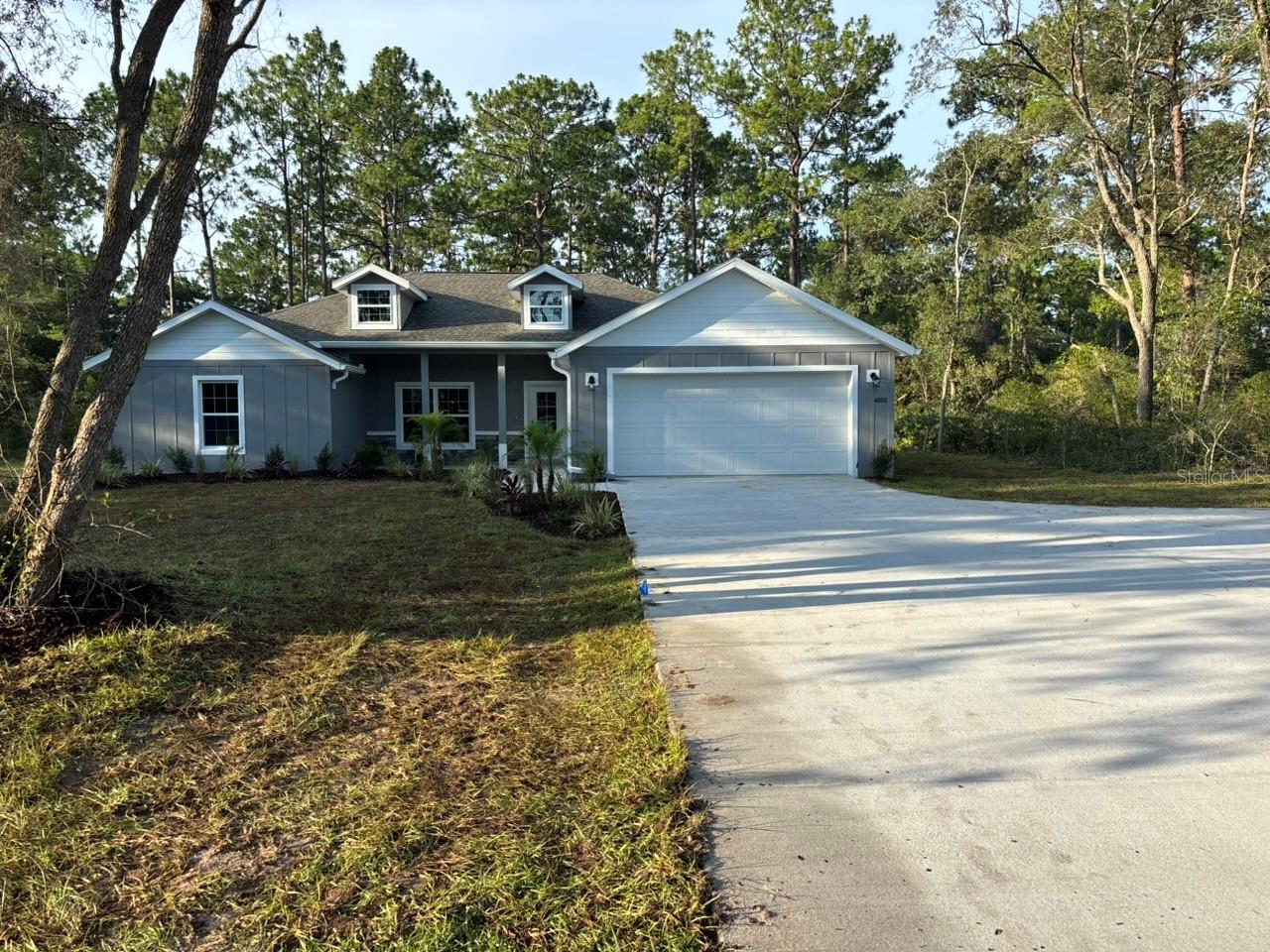 NEW CONSTRUCTION. This move-in-ready 2026 Captiva model is a 4-bedroom, 2-bath saltwater pool home offering 1,895 square feet on a full one-acre homesite in Pine Ridge. Built with concrete block and stucco construction, the home also features 30-year architectural shingles, energy-efficient double-pane windows, and a 10-year structural warranty.

The open, split-bedroom floor plan centers around a spacious great room and kitchen with granite countertops, an oversized island with abundant storage, subway tile backsplash, closet pantry, and included appliances. Luxury vinyl and tile flooring extend throughout the home.

The private primary suite includes a tray ceiling with crown molding and recessed lighting, two walk-in closets, dual vanities, and an oversized walk-in shower with dual shower heads. The guest bathroom also features a double vanity and marble-look tile. Additional highlights include generous closet space, a dedicated laundry room with cabinets and a granite folding counter, and a large mudroom that can also serve as an office or drop zone.

Sliding doors open to the screened outdoor living area and 12-by-21-foot in-ground saltwater pool with LED lighting. The pool includes basic cleaning equipment and a three-year equipment warranty. The property also offers a covered front porch, covered rear porch, rain gutters, irrigation system, attached two-car garage, expanded driveway, guest parking, and parking pad.

Located in Flood Zone X, the property is considered high and dry, with no flood insurance required. Pine Ridge amenities include a community center, dog park, playground, tennis and pickleball courts, equestrian facilities, and miles of riding and walking trails. Low annual HOA fee and no CDD.