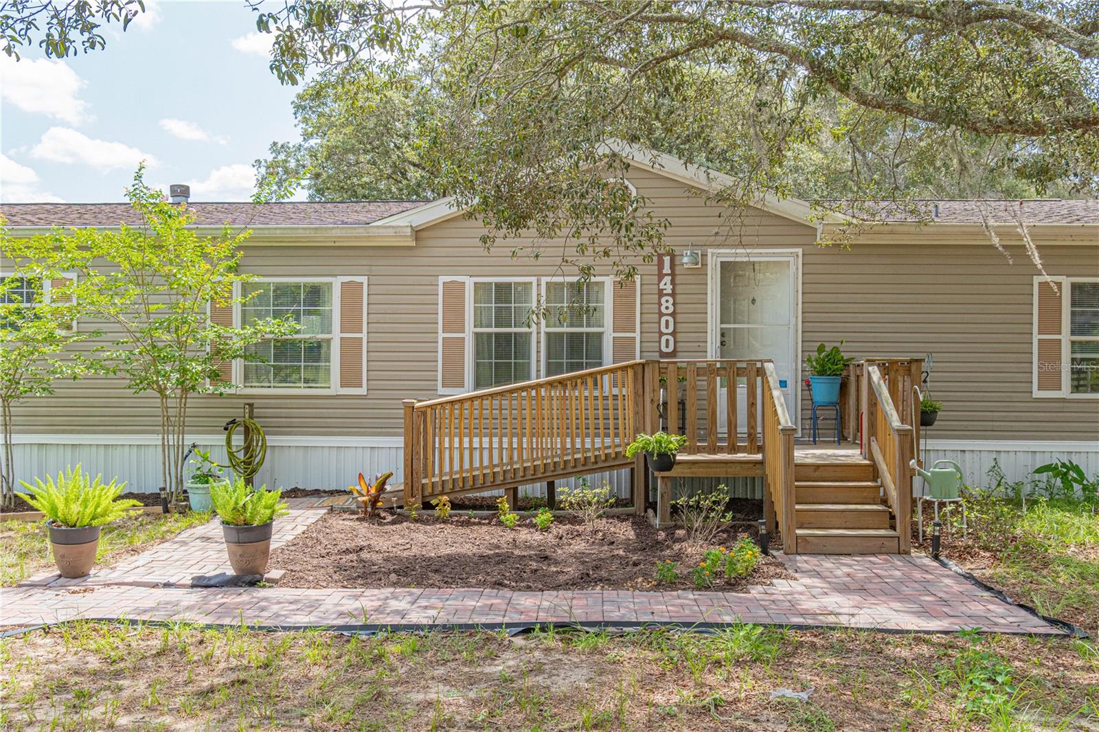 Welcome home to this charming 4-bedroom, 3-bathroom manufactured home nestled on 1.25 picturesque acres! Move-in ready with fresh interior paint, new carpet, new blinds and window treatments, and new toilets throughout. Cozy up to the wood-burning fireplace on cool evenings or step out onto the brand new 10x10 rear deck to enjoy your fully fenced yard - perfect for families, pets, and entertaining. 
The kitchen features a newer air fryer/convection range, and the home is equipped with a water softener (2023) and well pressure tank (2022) for added peace of mind. Two outbuildings with electric provide ample storage or workshop space. Major systems have been updated: roof (2018), A/C (2019), and gutters already in place. 
With room to breathe and so many updates already done, this property is ready for its next chapter. Don't miss it!