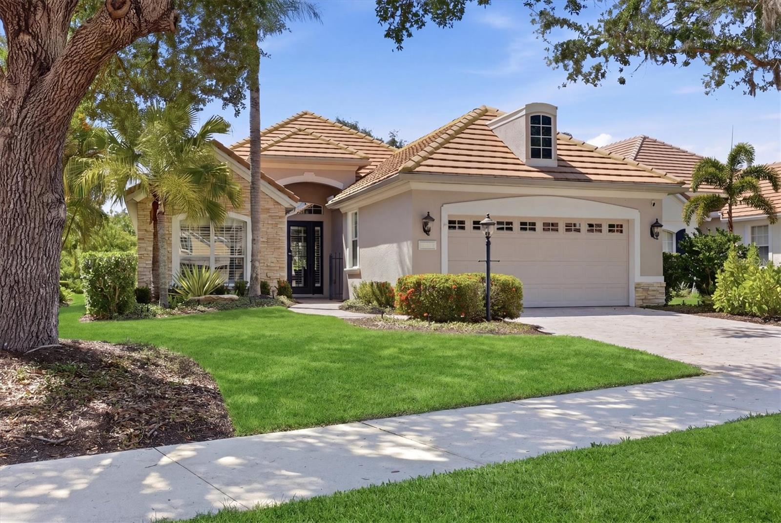 Nestled behind the gates of Lakewood Ranch Country Club, 7466 Edenmore Street offers the perfect blend of elegance, comfort, and maintenance-free living. This beautifully designed Neal Signature fully furnished home features 3 bedrooms, 2 baths, and an open-concept floor plan with soaring ceilings, abundant natural light, and timeless architectural details throughout. The spacious great room flows seamlessly into the gourmet kitchen, showcasing rich wood cabinetry, granite countertops, stainless steel appliances, and a generous breakfast bar ideal for entertaining. The spacious primary suite is a private retreat with tray ceilings, dual walk-in closets, a spa-inspired bath with separate vanities, soaking tub, and walk-in shower. Thoughtful upgrades including plantation shutters, updated lighting, fresh paint, crown molding, and ceramic wood-look flooring create a warm and invitng atmosphere. Sliding glass doors open to a covered lanai overlooking tranquil preserve and lake views, providing the perfect setting to relax and enjoy Florida’s indoor-outdoor lifestyle. Located in the highly sought-after Edenmore enclave, residents enjoy maintenance-free living with optional membership opportunities to the renowned Lakewood Ranch Country Club offering golf, tennis, fitness, dining, and social amenities. Conveniently located near UTC shopping and dining, top-rated schools, SRQ Airport, and the Gulf Coast’s award-winning beaches, this exceptional home delivers luxury living in one of Lakewood Ranch’s most desirable communities.