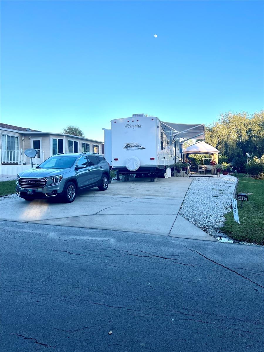 Experience the Florida lifestyle! This large lot in the Wilderness Town Park features a new 12'x8' shed with washer and dryer! Please note that you own the land, not rent. Amenities include a pool, hot tub, fitness center, access to the Ocklawaha River, fishing, shuffleboard, and hiking trails on the Florida Greenway. The community is gated, and the HOA covers the community pool, grounds maintenance, private roads, sewer, trash, and water services. Situated in the desirable Wilderness Town Park, you will be just minutes away from Silver Springs State Park, shopping, restaurants, and historic downtown Ocala. East coast beaches are approximately one hour away. Please note that you can purchase the furnished 40’ Hampton Destination Trailer that was recently remodeled in 2023 and roof resealed in 2022 separately for $6,000.
