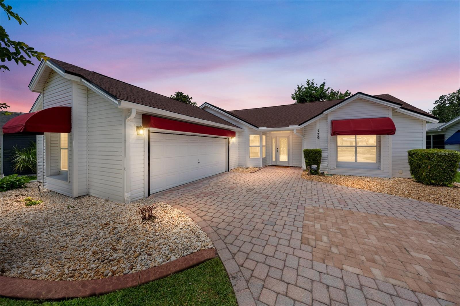 One or more photo(s) has been virtually staged. LOOK at this hidden gem! NO BOND, PRIME LOCATION, and a beautifully UPGRADED CORONADO Designer in the VILLAGE of EL CORTEZ! This 2 BR/2 BA/2 CAR GARAGE home w/ 1,242 SF of LA offers classic Villages convenience, just a quick golf cart ride to the US Hwy 441/27 COMMERCIAL CORRIDOR for shopping & dining, plus only 6 mins to SPANISH SPRINGS & 10 mins to LAKE SUMTER LANDING for FREE nightly entertainment! Recreation opportunities are nearby at Chula Vista & Rio Grande Rec Centers, executive golf, and Hacienda Hills Championship Golf. Curb appeal shines w/ burgundy awnings, a PAVERED DRIVEWAY & WALKWAY, mature landscaping w/ rock filled beds, and a welcoming FRONT PORCH. The front door features a full-length LEADED GLASS insert w/ matching sidelight and arched transom above. Inside, the tiled FOYER w/ coat closet and half wall opens to VAULTED CEILINGS over the LIVING / DINING area, east-facing windows, a glimmering contemporary chandelier, and WOOD LAMINATE FLOORING. The KITCHEN is highlighted by an arched entry w/ plant shelf, pass-through window w/ pendant lighting, WHITE CABINETS w/ crown molding & built-in pantry, white SUBWAY TILE backsplash, GRANITE COUNTERTOPS, and lower cabinet PULL OUTS. Premium FISHER & PAYKEL refrigerator and dishwasher pair w/ a smooth-top DOUBLE OVEN RANGE, undermount sink, and brushed nickel gooseneck faucet for a functional & attractive space. The BREAKFAST NOOK offers casual dining w/ a large double window, upper white cabinetry, and sliding glass door access to the ENCLOSED LANAI. Retreat to the PRIMARY SUITE w/ vaulted ceilings, tile floors, and custom closet organization system. The UPGRADED ENSUITE BATH features updated lighting, a granite-topped vanity, a square porcelain vessel sink w/ waterfall faucet, a private water closet, and a tiled ROMAN SHOWER w/ built-in corner seat, shower niche, handheld showerhead, and half wall entry point. The HALLWAY showcases a matching contemporary chandelier and has a convenient linen closet close to BR #2 & BA #2. BEDROOM #2 is located in the front of the home and has a double window & a closet w/ bi-fold doors. Adjacent BATH #2 presents a SOLAR TUBE, a single sink/vanity w/ framed mirror, updated lighting, and a WALK-IN SHOWER w/ white tile surround & sliding glass door. The 8' x 12' ENCLOSED LANAI has sliding windows, pull-down shades, tile flooring, and dual sliding-glass door access from the breakfast nook and living room.  Outside, a full-width painted concrete patio spans the rear of the home w/ a 9’x16’ white pergola (2021) w/ retractable awning underneath. The 2-CAR GARAGE includes a MOTORIZED GARAGE DOOR SCREEN, Washer (2020), Dryer (2019), storage shelving, attic pull-down stairs, extra attic insulation (blown), and reinforced-strut garage door updates (2025).  Other updates include ARCH SHINGLE ROOF (2023), HVAC (2025), HWH (2023), gutters/downspouts w/ GUTTER GUARDS, AC ducts cleaned (2025), whole-house water softener & purification system, and SMART-HOME controls for Nest thermostat, irrigation sprinklers, Blink doorbell camera, and SimpliSafe alarm system. Yes, NO BOND, PRIME LOCATION, UPDATES, and the renowned VILLAGES LIFESTYLE come together beautifully here. Start “Lovin’ the Lifestyle” of The Villages w/ its legendary recreation amenities - FREE nightly entertainment at 3 town squares, complimentary year round executive golf, 3500+ social clubs AND the opportunity to make this lovely PERSONAL SANCTUARY your own. Schedule your private showing TODAY!