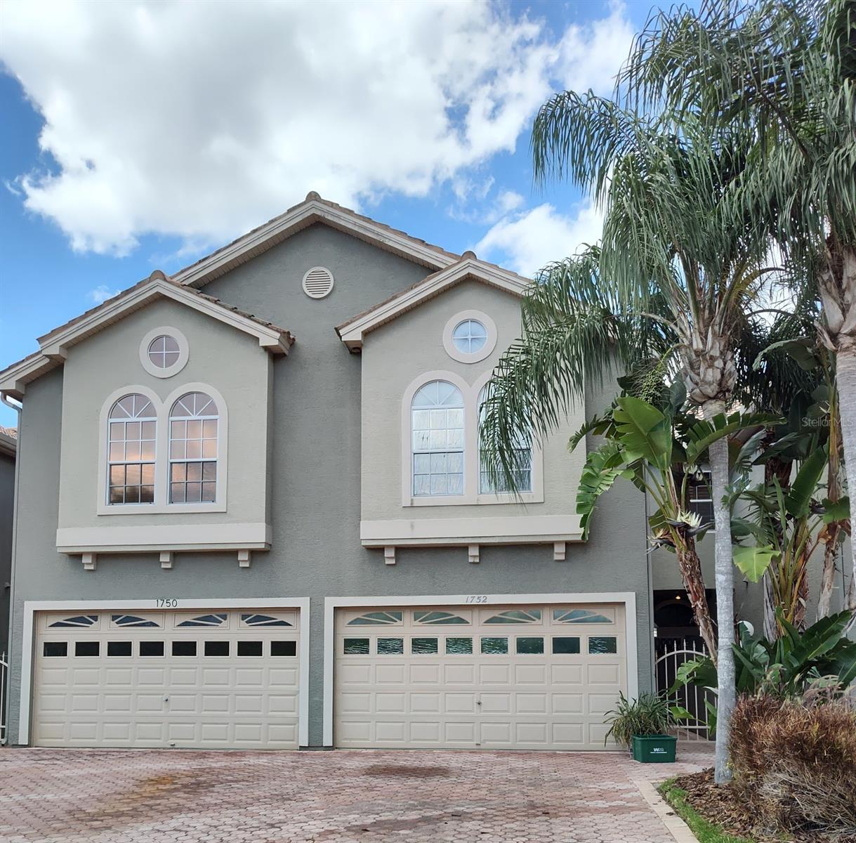 WATER VIEWS! Great PALM HARBOR location! All from this spacious canal waterfront 3 bedroom, 4  bath townhome with a 2 car garage! Located minutes from grocery store, shopping and eateries! Large living room has a fireplace as well as a lovely water view of the canal. Sliding door lead out to a screened enclosed patio for your enjoyment any time of the day! Features large Kitchen, separate dining area for your holiday gatherings. Upstairs is the large master bedroom with a fireplace, walk in closet and en-suite bathroom. Master bedroom has sliding doors that open onto a screened in balcony with a beautiful water view. The other 2 bedrooms are good sized rooms! Tarpon canal allows for small water crafts to enjoy the Florida sun! Heading out to Lake Tarpon, a large freshwater lake known for fishing and fun in the sunshine!