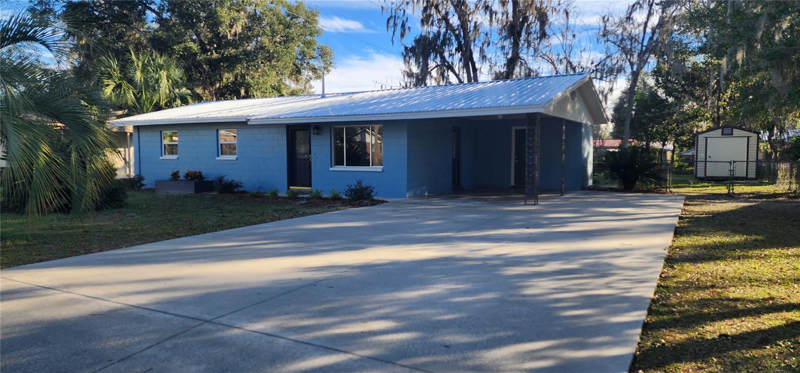 Great for a starter home or to down-size! This home has a brand new metal roof, new paint, new light fixtures, new wood laminate floors, new kitchen cabinets and quartz countertops, new appliances, french doors to the screened porch. There is a separate laundry room under the carport. It has a chain-link fenced yard and a shed. Great home for under 200K.