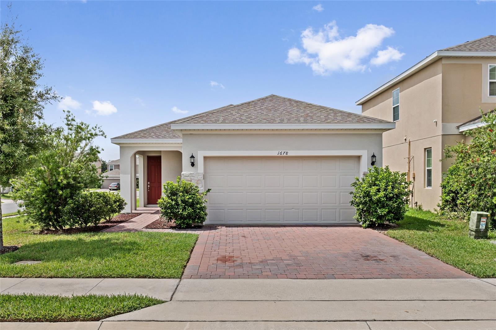 Welcome to this beautifully maintained 4-bedroom, 2-bathroom home built in 2022, offering modern comfort and thoughtful upgrades throughout. The open-concept floor plan creates the perfect space for both everyday living and entertaining, with abundant natural light flowing through the main living areas. The stylish kitchen features stainless steel appliances, modern cabinetry, ample counter space, and a large island overlooking the living and dining areas. The spacious primary suite serves as a private retreat, complete with a luxurious en-suite bathroom featuring a thermostatic rain shower system that allows you to preset and maintain your preferred water temperature for a spa-like experience. Designed with convenience in mind, this home includes smart home features such as an app-controlled garage door opener and a smart front door lock that lets you program a secure entry code for keyless access, while still allowing you to use a traditional key whenever needed for added peace of mind. Step outside to enjoy the covered lanai and backyard, perfect for relaxing or entertaining. Conveniently located near shopping, dining, major highways, schools, and Central Florida attractions, this move-in-ready home offers the perfect combination of style, comfort, and modern technology. Schedule your private showing today and experience all this exceptional home has to offer!