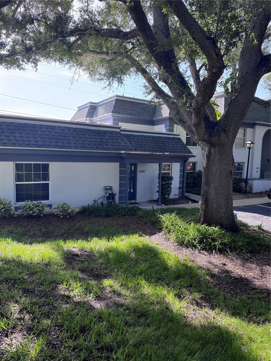 Welcome to this charming 2-bedroom, 1.5-bath condominium in the desirable Kapok Manor community of Clearwater. This first-floor end unit offers a comfortable and inviting layout with approximately 970 square feet of living space, plus a spacious enclosed, air-conditioned bonus room with closet storage that adds exceptional versatility and value.

The bonus room is a standout feature of the home, offering flexible space that can be enjoyed as a home office, guest retreat, den, hobby room, reading area, or additional living space. With its own door leading to the side of the property, this unique space provides added convenience and easy access to the outdoors, making it perfect for enjoying the Florida lifestyle.

The thoughtfully designed floor plan features a bright living area, functional kitchen, two bedrooms, one full bathroom, one half bathroom, and convenient washer and dryer hookups. A new roof installed in 2021 provides added peace of mind for the next owner.

Kapok Manor offers a beautifully maintained community setting with resort-style amenities including a pool, clubhouse, tennis courts, and fitness facilities. The HOA provides added value with included services such as water, pest control, cable, and internet (buyer to verify). Enjoy the convenience of community-maintained amenities and a well-kept neighborhood environment.

Enjoy the peaceful surroundings of Kapok Manor with mature landscaping and community amenities including a pool, clubhouse, tennis courts, and fitness facilities. Ideally located near shopping, dining, Ruth Eckerd Hall, Safety Harbor, Clearwater, Tampa International Airport, and major roadways.

This home offers comfort, convenience, and versatility in a desirable Clearwater location. Schedule your showing today!