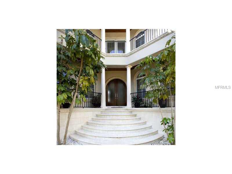 Beautiful Davis Island Waterfront home.  Glass NanaWall System opens the back of the house to the pool and the waters of Tampa Bay, to "invite the outside in".  You will naturally spill out onto the covered Lanai, pool and dock.  Same glass system in upstairs Master, opens the room out to the balcony, with gorgeous water views and sunsets.  Exotic marbles in gourmet kitchen and the bathrooms.  Travertine floors on first level, walnut and Brazilian cherry on second floor.  Media room, with en suite full bath, could easily be converted into a 5th bedroom.  Outdoor kitchen, wine cellar, fireplace, large office/study with French doors, camera security system, spacious laundry room and 3 car garage.  This home has a contemporary, yet Mediterranean flair, thatprovides the lifestyle to enjoy all of the island charm.  Davis Island has a variety of shops and restaurants, a hospital, and it's very own Peter O'Knight Airport, all nestled in closely to nearby downtown Tampa.