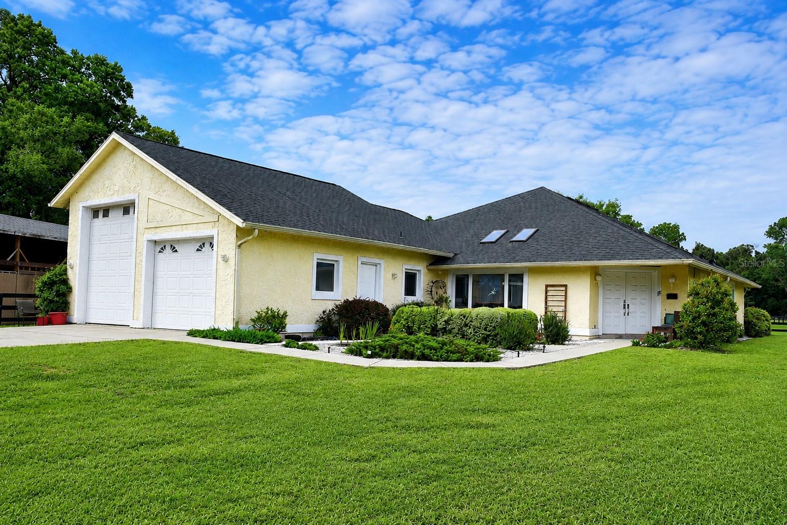 Welcome to this exceptional 6.5-acre mini farm in the highly desirable Meadow Wood Farms community, an equestrian-friendly neighborhood ideally located just 14 minutes from the World Equestrian Center and 19
minutes from HITS, with easy access to Ocala’s premier attractions and amenities. Designed with both horse enthusiasts and comfortable country living in mind, the property features three fenced paddocks with new
fencing, a metal round pen, and a well-built horse shed constructed in 2022 with room for up to three stalls. The impressive 2024 barn offers three stalls, a tack room, feed room, hay storage, shaving room, and
workshop, all thoughtfully arranged to make unloading feed and shavings simple and efficient. The 1,731-square-foot home offers a bright, open-concept design with two spacious primary suites and two full bathrooms.
The modern kitchen features a breakfast bar and flows seamlessly into the living and dining areas, creating an inviting space for everyday living and entertaining. Architectural details, including multiple skylights,
picturesque windows, and wall-to-wall sliding glass doors, fills the home with natural light and showcase beautiful views of the surrounding landscape. Step outside to the expansive screened-in patio, where you can relax
and enjoy breathtaking sunsets overlooking the lush pastures—a perfect setting for barbecues, family gatherings, and entertaining guests.  The home also features an oversized garage with enough space to
accommodate an RV and a dedicated 30-amp hookup. For added peace of mind, the roof and skylights were replaced in 2021, and a new 3.5-ton Tempstar HVAC system was installed in 2025. The home also features a
central vacuum system, whole-house water filtration system, and a private electric gated entrance. Meticulously maintained and thoughtfully improved, this beautiful mini farm offers the perfect combination of pride of
ownership, functionality, and endless possibilities. Schedule your private showing today and experience everything this remarkable property has to offer.