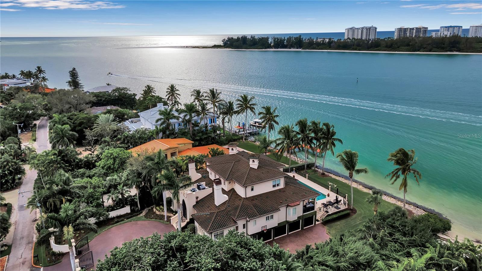 EXQUISITE HOME. "Every detail considered"  WHERE SARASOTA BAY MEETS THE GULF OF MEXICO.  NORTH SIESTA KEY. Do not miss this unparalleled opportunity to own an exquisite waterfront home, where luxury, location, and breathtaking views combine to create the ultimate island sanctuary. This timeless residence, nestled on Big Pass at the entrance to the Gulf of Mexico, promises an exceptional lifestyle. The main home was untouched by hurricane waters, with only minimal cleanup needed in the non-conforming space. After the recent hurricanes, no water intrusion has been noted, underscoring the home’s robust construction. The sellers have invested in a brand-new tile roof, ensuring long-term value and peace of mind—even though the existing roof had years of life left. 
Elegantly appointed, this home offers an effortless transition for new owners, allowing immediate enjoyment. Located on the coveted north end of Siesta Key, the home provides unrivaled beach access and sweeping views of the Gulf of Mexico and Big Pass. Whether it's spectacular sunrises, sunsets, or the tranquility of island living, this residence is a true escape. Siesta Key has been recognized as the number one beach in the United States multiple times by Dr. Beach.  The soft white sand is made almost exclusively of pure quartz, which remains cool on the feet even when baked in the Florida sun.
Step inside to experience the grandeur of this architectural masterpiece by a well-renowned architect. The open-concept living space flows seamlessly, with soaring ceilings and floor-to-ceiling impact windows framing panoramic, 180-degree views of the sparkling waters. A private elevator transports you between levels, adding both convenience and sophistication. The gourmet/chef's kitchen, equipped with high-end appliances (Wolf, Miele, etc.), sets the stage for both intimate meals and grand entertaining.
This home’s five spacious en-suite bedrooms, provide luxurious comfort and privacy. Designed for light and air, every room offers stunning vistas, creating an inviting and serene atmosphere. The property has undergone over $3 million in upgrades since 2020, ensuring that every detail is perfect. From Italian plaster and book-matched Calcutta Gold marble to custom wood floors and a bespoke Clive Christian kitchen, the Kohler natural gas generator supplies the entire home, three fireplaces, an elevator, a central vacuum, and 2 Tesla car chargers, no expense has been spared.  Furnishing may be purchased separately.  
Smart home features include Lutron lighting, an integrated security system, and commercial-grade Wi-Fi in every room, ensuring modern convenience at your fingertips. Additional amenities include a four-car garage, a 40x20 pool and spa, a custom walnut library, a cellular gate call box, Seura TV mirrors in the primary and in the second primary suite, with elevator access, and motorized window blinds complete this extraordinary residence.
This is a rare opportunity to own a once-in-a-lifetime waterfront home on Siesta Key. With its unparalleled location, stunning design, and luxury upgrades, this residence epitomizes elevated island living. Don’t miss the chance to call this exceptional residence HOME.