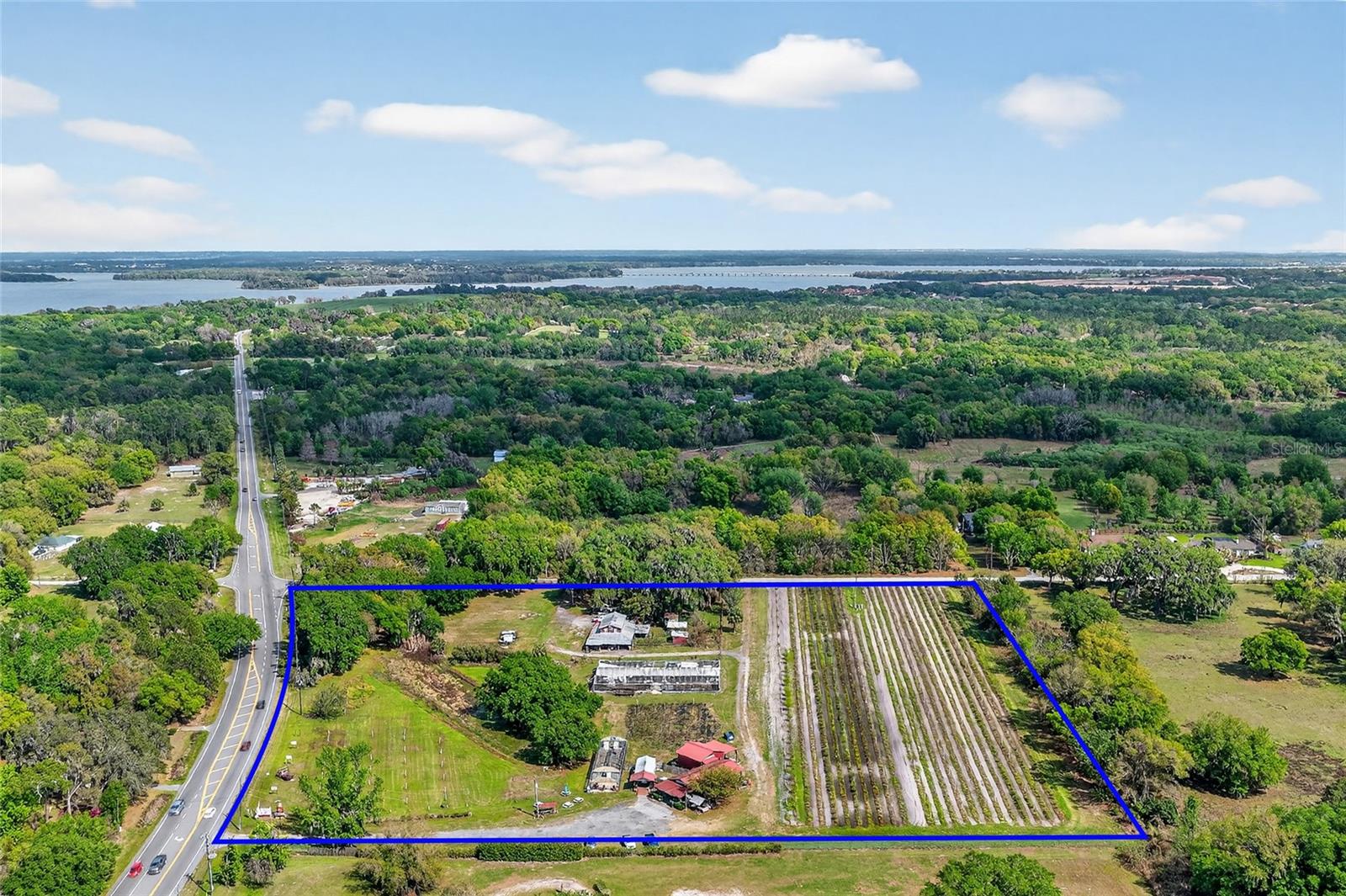 Offered is a rare opportunity to own a 9 acre corner in the high growth area of Yalaha, Florida.  Currently zoned agricultural, this amazing corner hosts a u-pick blueberry, blackberry and peach farm along with a locally famous distillery, the Yalaha Bootleggers.    With over 650' of frontage on CR 48 and 785' of frontage on Bloomfield Ave this property is still an open canvas that is ready for you expansion or re-development.   As you pull off of CR - 48 you will be greeted by the Farm Store where the Bootleggers' Moonshine is sampled and sold, along with a small commercial kitchen that makes pies, pickles of all types and food for weekend events.   A large, new 'Still House' sits just to the rear of this.   Toward the corner of Bloomfield, an existing 1725 s.f home from 1928 sits in great shape.  A large barn with an air bnb apartment upstairs sits just next to the home.  This would make a great wedding venue / agro-tourism businesses / or a great future development location with Thousands of houses approved for development within a small radius.  The Villages sits just a few miles up the road on CR-48 once you cross 27 along with an exit to the Turnpike / I-75.    Tavares, Leesburg, Howey in the Hills, Clermont and Montverde are all within a short distance as this location is positioned perfectly on CR 48 between HWY 19 and US 27.   Inquire with your agent today.