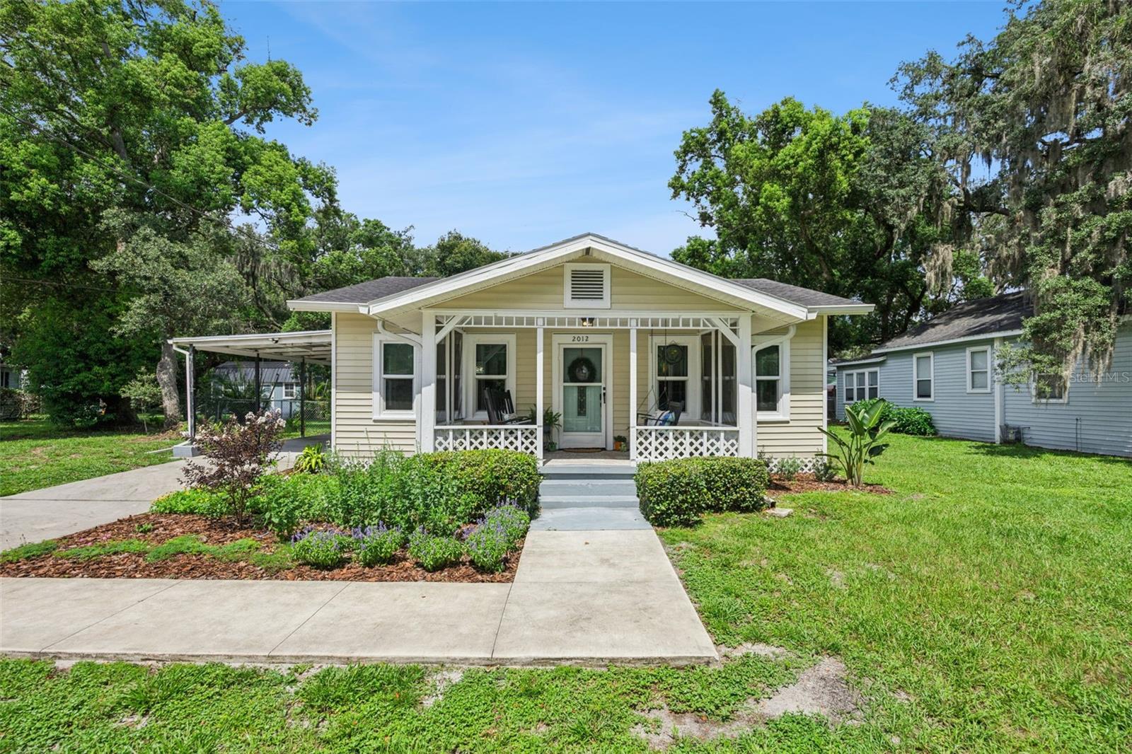 Nestled in Sanford's highly desirable Golf Cart District, this charming 2-bedroom, 1-bath bungalow offers the perfect blend of character, comfort, and convenience. Fresh landscaping and a welcoming front porch with a porch swing and plenty of seating create the perfect spot to enjoy your morning coffee or unwind at the end of the day.
Inside, you'll find a bright, open floor plan filled with natural light, enhanced by newer windows, neutral paint, and easy-care laminate flooring throughout. The spacious family room flows seamlessly into a large dining area, providing an ideal setting for everyday living and entertaining family and friends.
The kitchen is tucked away at the rear of the home and features stainless steel appliances, shaker-style cabinetry, and great cooking space, offering both style and functionality. The secondary bedroom is situated at the front of the home and is filled with natural light from multiple windows overlooking the front yard. The generously sized primary bedroom is privately located at the back of the home, offering plenty of space for a sitting area or home office. Both bedrooms include walk-in closets for exceptional storage.
The bathroom features a single-sink vanity and a shower/tub combination, while the laundry and utility room is conveniently located at the back of the home with direct access to the covered patio. Step outside to discover a huge, fully fenced backyard with endless possibilities for gardening, recreation, pets, or future expansion. A detached one-car garage provides secure parking or excellent storage, while the attached one-car carport offers additional covered parking.
Ideally located just minutes from the heart of historic Downtown Sanford, you'll enjoy easy access to popular restaurants, breweries, boutiques, parks, waterfront activities, community events, and everything this vibrant area has to offer. This move-in-ready bungalow is the perfect place to enjoy the best of Sanford living.