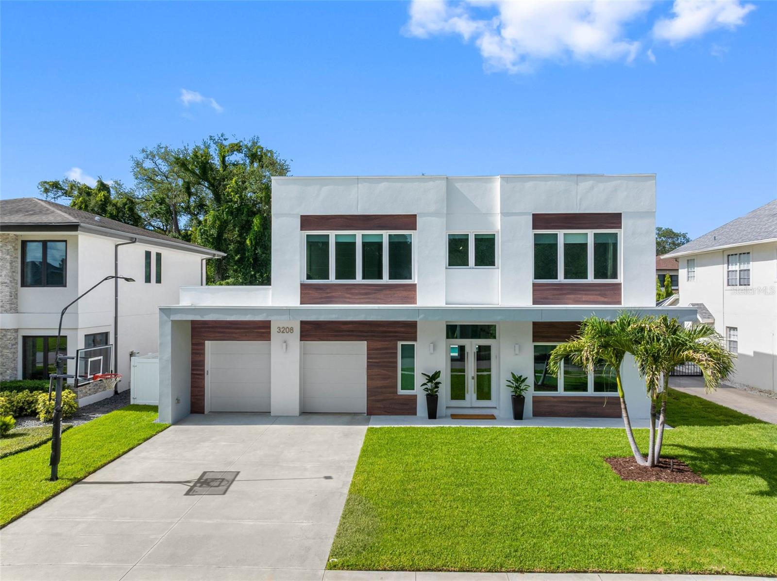 Welcome to this exceptional modern home that combines luxury, comfort, and functionality in one of the best neighborhoods of South Tampa: Bayshore Beautiful.

This energy-efficient home was thoughtfully built to withstand Florida’s weather. Located in a non-flood zone, it boasts two-story concrete construction, PGT hurricane-resistant windows, and a flat TPO 60 membrane roof with 5" insulation.

French glass doors welcome you into an impressive hallway. The abundance of natural light, along with soaring 11-foot ceilings on both floors, makes the home feel spacious and airy. On the right, barn doors open to a private office with custom built-ins. Located next to a full bath, it offers the flexibility to be used as a fifth bedroom, family room, or flex room. 

The living, dining, and kitchen areas flow seamlessly together, creating the perfect setting for entertaining. Open the multiple 8-foot-high sliding glass doors and make your own outdoor paradise part of your everyday lifestyle.

Enjoy the heated saltwater pool and spa, complete with a water fountain and multicolor lighting. Landscape lighting enhances the outdoor ambiance, while the 88-inch Maverick ceiling fans provide a refreshing breeze on summer evenings. If you prefer an enclosure, the footings are already in place.

The kitchen is a chef's dream in both size and functionality. It features two large sinks, quartz countertops and backsplashes, and a massive waterfall island. Premium drawer cabinetry makes it easy to access cookware and utensils while providing ample storage for seasonal dishes.

A pot filler over the six-burner Fulgor Milano dual-fuel range and a professional range hood add functionality to everyday cooking. The under-counter microwave also functions as a second convection oven and offers speed-cook capabilities, among other features.

A generous walk-in pantry with custom built-ins and drawers completes this exceptional kitchen.

The staircase to the second floor features 2" solid wood treads and sleek cable railings, enhancing the minimalist design of the home.

Upstairs, you will find a spacious family room, a laundry room, and four generously sized bedrooms. Each bedroom features its own en-suite bathroom with glass-enclosed showers, custom closets, window treatments, and Minka ceiling fans known for their quiet operation and distinctive style.

The laundry room boasts a sink, cabinetry, and a hanging rack for added convenience.

The primary suite features his-and-her walk-in closets, while the spa-inspired primary bathroom offers dual vanities, a makeup station, a freestanding soaking tub, and a spacious walk-in shower, creating the perfect retreat at the end of the day.

Additional features include built-in storage throughout the home, solid-core doors, Lutron Caséta lighting controls, app-controlled garage doors, thermostats, security system, dishwasher, washer, dryer, and lighting. Additionally, the home is wired for optimal internet connectivity. It provides an RV hookup, a water softener, a gas tankless water heater, irrigation, and sprinklers.

Conveniently located just a few blocks from Bayshore Blvd., the YMCA, and tennis and basketball courts. Zoned for A-rated schools (Roosevelt, Coleman, and Plant). Just a two-minute drive to the Selmon Expressway, Target, Publix, and Britton Plaza, and only ten minutes from downtown Tampa, Hyde Park, Tampa General Hospital, and the Gandy Bridge to St. Pete beaches.