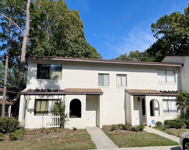 Don't miss this exceptional corner unit townhouse located in the desirable SW side of Gainesville, perfect for both families and investors. This well-maintained unit boasts 3 good size bedrooms and 2.5 updated bathrooms, offering a convenient first-floor bedroom and half bath, as well as two additional bedrooms and two full bathrooms on the second floor. The living/dining room and updated kitchen, complete with stainless steel appliances and newer countertops, make it ideal for entertaining. Main living areas and bathrooms are tiled, and beautiful dark laminate in all bedrooms. Additional amenities include a laundry closet equipped with washer and dryer, a relaxing screened-in porch, and a community pool just steps away across the parking lot. Roof was just replaced 2 weeks ago and Water Heater replaced in 2022. With a bus line that stops directly in front of complex, enjoy easy commutes to the University of Florida, Butler Plaza and Celebration Pointe, and a multitude of dining and entertainment options.