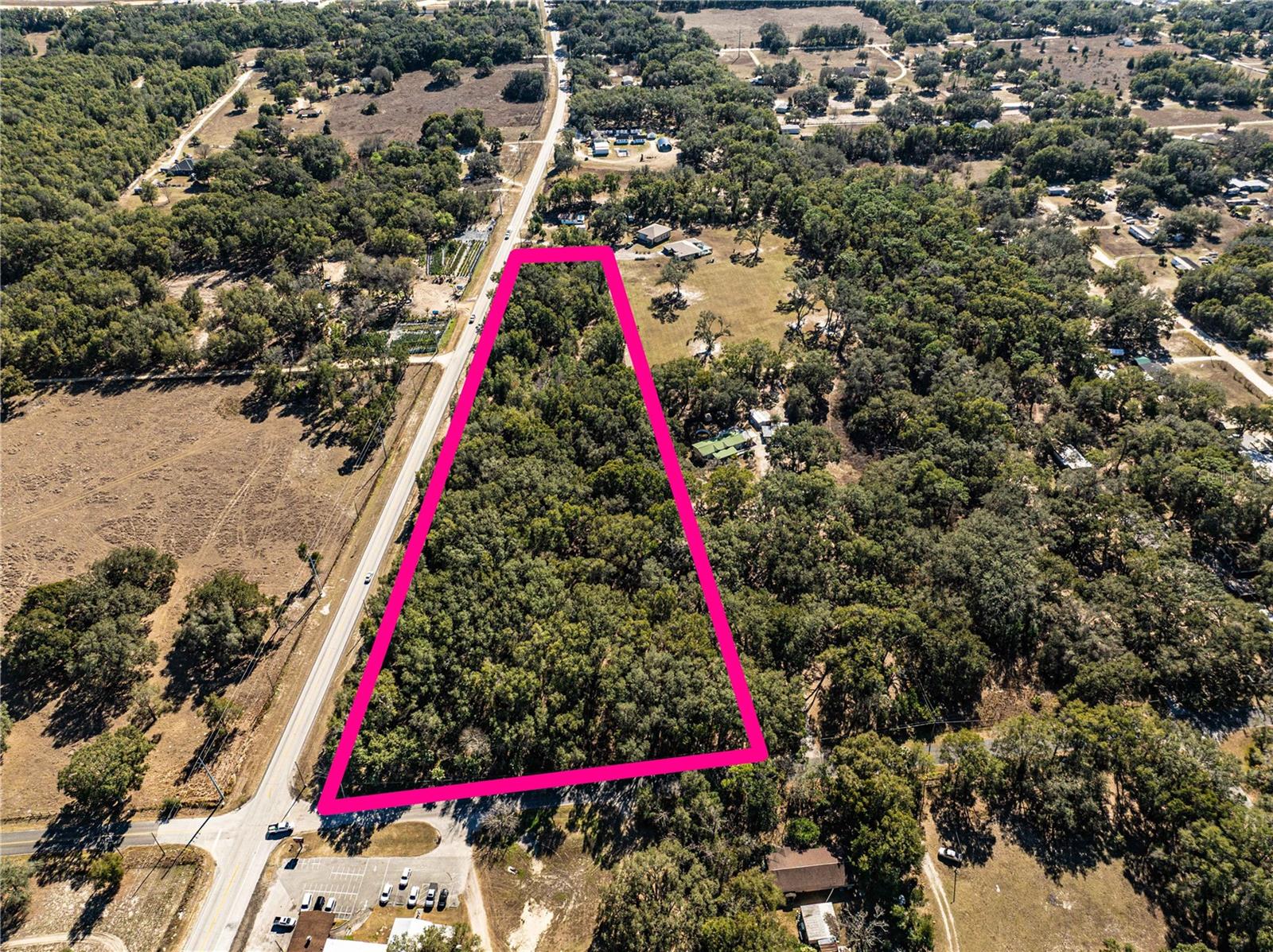 This 6.28± acre B-2 (Community Business) zoned parcel presents a prime commercial development opportunity in the growing South Marion County corridor. Situated on CR 25 in Weirsdale, just minutes from U.S. Hwy 441, the property is strategically positioned between established and expanding residential communities including Stonecrest, The Villages – Orange Blossom Gardens, and Lakes of Lady Lake — providing immediate proximity to a dense and affluent consumer base. The area is experiencing active commercial expansion, with nearby recent and proposed developments including new climate-controlled self-storage facilities, RV/boat storage projects, and additional commercial land activity along the 441 corridor. This surrounding growth reflects increasing demand for service-oriented retail, storage, medical, and business uses in this high-visibility regional trade area. With flexible B-2 zoning allowing for a broad range of commercial applications (buyer to verify permitted uses), the site is well-suited for storage, retail, professional office, medical, or mixed commercial development. Strong roadway access, surrounding rooftops, and continued corridor growth make this an attractive development or land-bank opportunity in one of Marion County’s advancing commercial pockets.