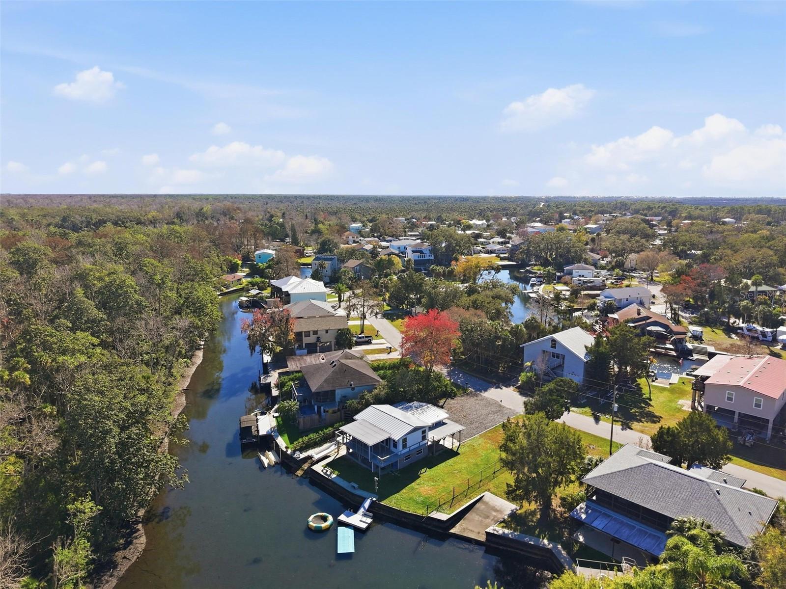 Extraordinary opportunity to own a waterfront property off the Weeki Wachee River. Situated on a spacious lot and a half with approximately 80 feet of direct waterfront. Witness the captivating presence of manatees, dolphins and exotic birds in the comfort of your own backyard or private dock. Step inside to discover a beautifully updated 2 bedroom, 2 bathroom home that delivers the perfect balance of luxury and comfort. Designed with both style and durability in mind, the home features a new (2024) metal roof, along with new aluminum soffit, fascia and gutters for long-term peace of mind. Inside, the home showcases real wood cabinetry paired with elegant stone countertops and stainless steel appliances, creating a refined and functional kitchen space. Luxury vinyl plank flooring runs throughout, complemented by new baseboards and fully updated interior and exterior doors. Additional upgrades include new AC systems, windows, light fixtures, outlets and switches-ensuring a move in ready experience with no detail overlooked. Property offers endless opportunities for swimming, kayaking, fishing, boating and exploring. As well as a rare feature, the property includes a private boat ramp. The 7.5 mile long Weeki Wachee River is fed by crystal clear springs, has a constant 74 degree temperature, weaves through a state park to its endpoint at the Mud River, flowing into the Gulf of Mexico at Bayport. Navigate seamlessly to the Gulf with no fixed bridges hindering your way. Enjoy easy access to nearby Rodger's Park, Pine Island Beach and the world famous Weeki Wachee Springs State Park. Weeki Wachee Gardens, a spring-fed riverfront community in Hernando County, is conveniently situated one hour north of Tampa International Airport via the Suncoast Parkway. Isolated off US 19 and SR 50. Don't miss out on your chance to own a slice of paradise.
