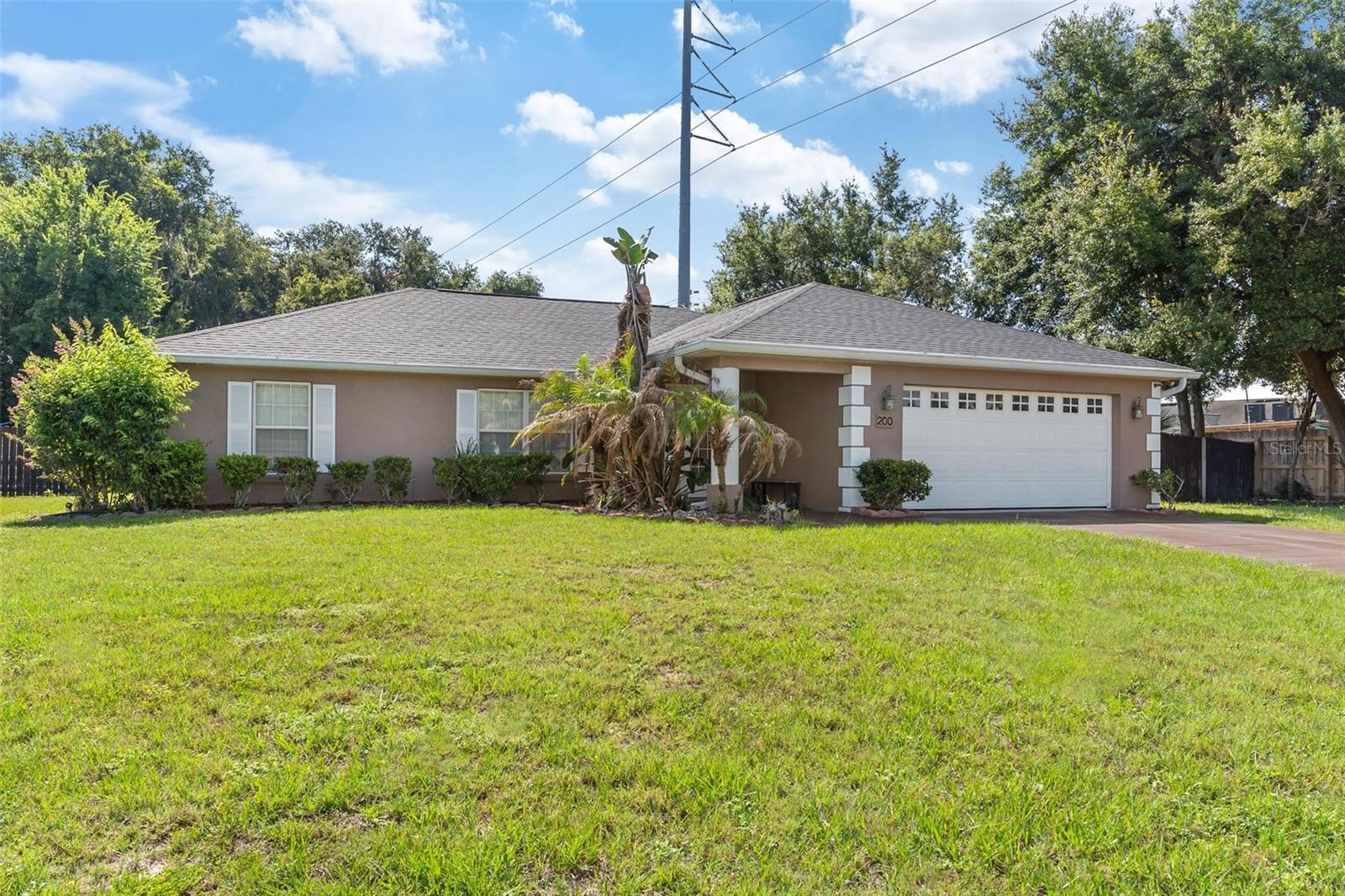 Lake Griffin community access | 3BR/2BA | Just under ½ acre | Fully fenced yard | 900 sq. ft. workshop | NEW 2026 roof | No carpet!
Imagine coming home to a property that offers the perfect blend of comfort & functionality. Situated on just under a half-acre with a fully fenced backyard and community access to beautiful Lake Griffin, this 3-bedroom, 2-bath home is designed for both everyday living and endless possibilities. From the moment you walk through the front door, you'll fall in love with the open floor plan and the beautiful wood plank tile flooring that flows throughout the home—completely carpet free. The spacious layout allows the living room, dining area, and kitchen to seamlessly connect, creating the perfect space for entertaining while still feeling warm and inviting.The kitchen overlooks the main living areas and features granite countertops, a closet pantry, and a window overlooking the outdoors, making meal preparation both functional and enjoyable. The split floor plan. The primary suite features walk-in closet and an ensuite bathroom featuring dual vanity sinks, a garden tub, and a separate walk-in shower. On the opposite side of the home, Bedrooms 2 and 3 share a well-appointed guest bath with a shower/tub combination. Step outside to one of the home's most enjoyable features—a screened-in patio that extends across most of the back of the home, creating the perfect place to sip your morning coffee, unwind after a long day, or entertain while overlooking the spacious backyard. For those needing extra space, this property truly stands apart with an incredible 900-square-foot detached garage/workshop. Whether you're a car enthusiast, woodworker, hobbyist, or simply in need of exceptional storage, this versatile building offers endless opportunities. The expansive fenced yard provides plenty of room for pets, gardening, outdoor activities, or even storing your boat or recreational toys. Adding even more value and peace of mind, the home features a brand-new roof (2026) and a newer hot water tank, allowing buyers to move in with confidence. Conveniently located less than 10 minutes from Downtown Leesburg, Beacon College, ViaPort Mall, shopping, restaurants, medical facilities, and everyday conveniences, this home offers the perfect balance of living with easy access to everything you need. With lake access, a large lot, a phenomenal workshop, major updates, and a desirable open layout, this is a rare opportunity to own a property that truly has it all.