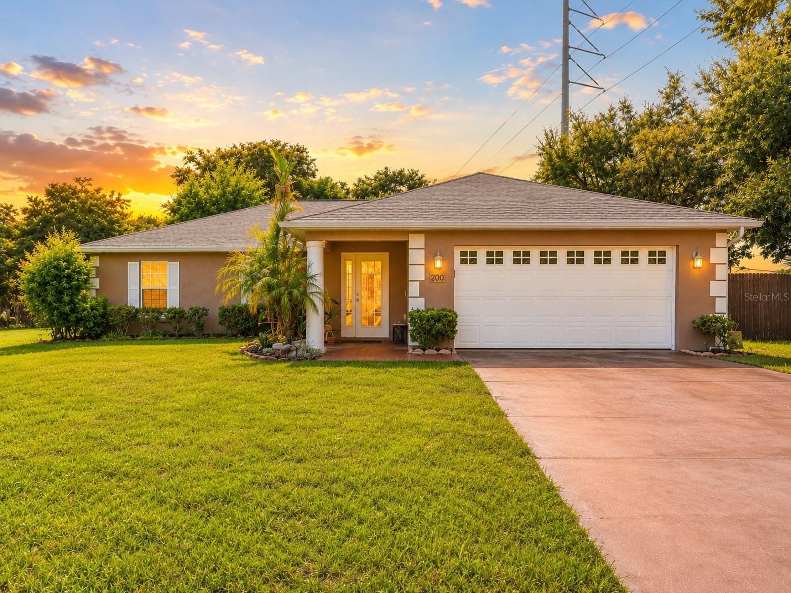 Lake Griffin community access | 3BR/2BA | Just under ½ acre | Fully fenced yard | 900 sq. ft. workshop | NEW 2026 roof | No carpet!
Imagine coming home to a property that offers the perfect blend of comfort & functionality. Situated on just under a half-acre with a fully fenced backyard and community access to beautiful Lake Griffin, this 3-bedroom, 2-bath home is designed for both everyday living and endless possibilities. From the moment you walk through the front door, you'll fall in love with the open floor plan and the beautiful wood plank tile flooring that flows throughout the home—completely carpet free. The spacious layout allows the living room, dining area, and kitchen to seamlessly connect, creating the perfect space for entertaining while still feeling warm and inviting.The kitchen overlooks the main living areas and features granite countertops, a closet pantry, and a window overlooking the outdoors, making meal preparation both functional and enjoyable. The split floor plan. The primary suite features walk-in closet and an ensuite bathroom featuring dual vanity sinks, a garden tub, and a separate walk-in shower. On the opposite side of the home, Bedrooms 2 and 3 share a well-appointed guest bath with a shower/tub combination. Step outside to one of the home's most enjoyable features—a screened-in patio that extends across most of the back of the home, creating the perfect place to sip your morning coffee, unwind after a long day, or entertain while overlooking the spacious backyard. For those needing extra space, this property truly stands apart with an incredible 900-square-foot detached garage/workshop. Whether you're a car enthusiast, woodworker, hobbyist, or simply in need of exceptional storage, this versatile building offers endless opportunities. The expansive fenced yard provides plenty of room for pets, gardening, outdoor activities, or even storing your boat or recreational toys. Adding even more value and peace of mind, the home features a brand-new roof (2026) and a newer hot water tank, allowing buyers to move in with confidence. Conveniently located less than 10 minutes from Downtown Leesburg, Beacon College, ViaPort Mall, shopping, restaurants, medical facilities, and everyday conveniences, this home offers the perfect balance of living with easy access to everything you need. With lake access, a large lot, a phenomenal workshop, major updates, and a desirable open layout, this is a rare opportunity to own a property that truly has it all.
