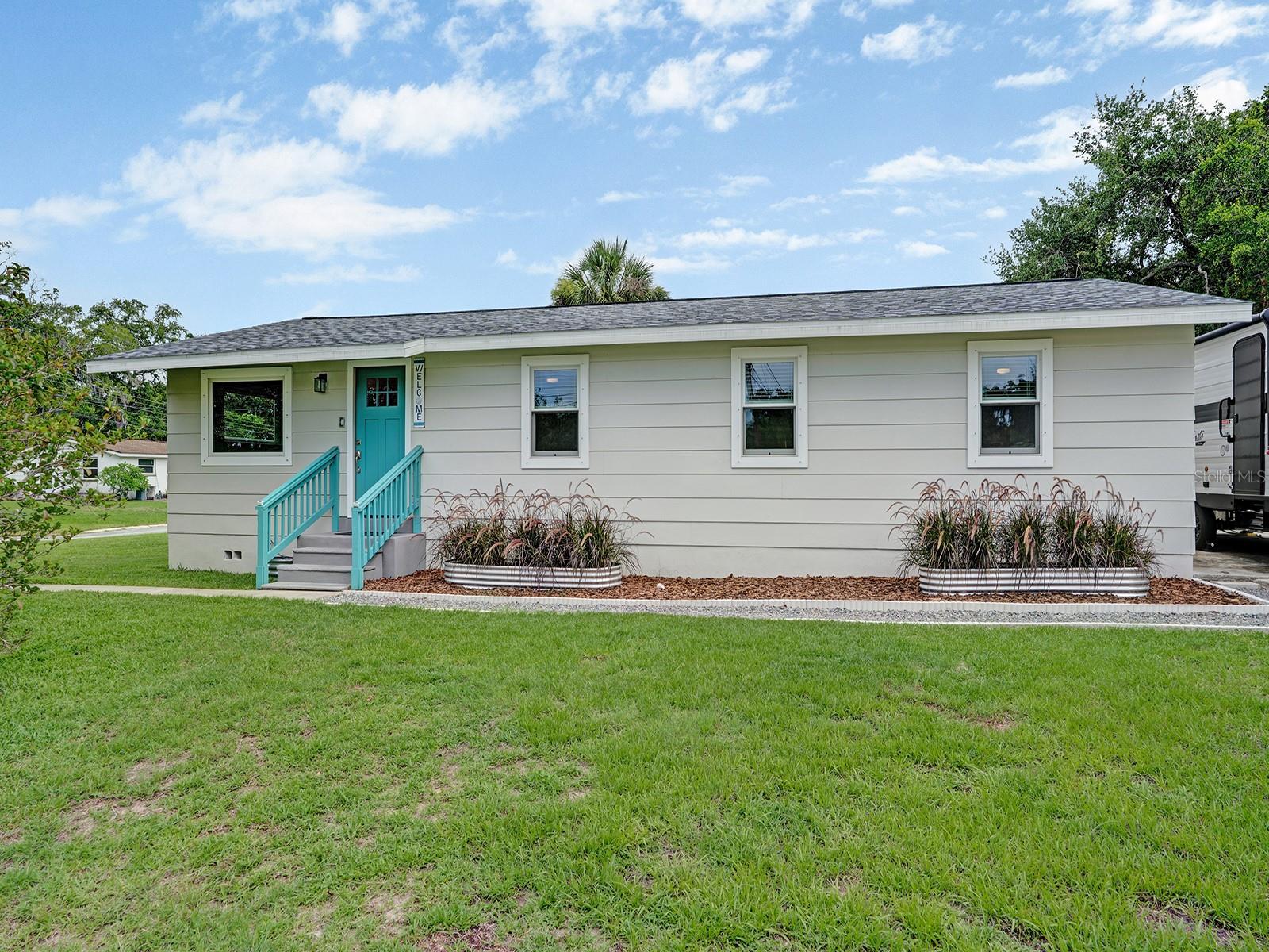 Completely renovated from top to bottom and move-in ready, this beautifully updated home is situated on a desirable corner lot at the end of a quiet street and has never flooded! Extensive improvements provide peace of mind, including a new roof, new plumbing, new electrical system, new subfloor, new flooring, new trim, new interior doors, new Anderson windows, and beautifully updated bathrooms. The stunning kitchen has been completely remodeled with maple soft-close drawers, butcher block countertops, and high-end Samsung appliances, creating a warm and inviting space for cooking and entertaining. Additional upgrades include a new tankless water heater and a well-maintained 2016 AC system. Outside, you'll find a fully fenced backyard with a new deck, outdoor shower, and a 2023 shed equipped with electricity and a roll-up door, offering excellent storage or workshop space. RV owners will appreciate the convenient 50-amp hookup, while hurricane shutters provide added protection during storm season. The home also features durable cement board siding and a solid concrete foundation. Ideally located just minutes from downtown, you'll enjoy easy access to a variety of dining, shopping, entertainment, and community events while still enjoying the privacy of a quiet location. With quality upgrades throughout, exceptional outdoor amenities, and a prime location, this home is truly ready for its next owner to enjoy.