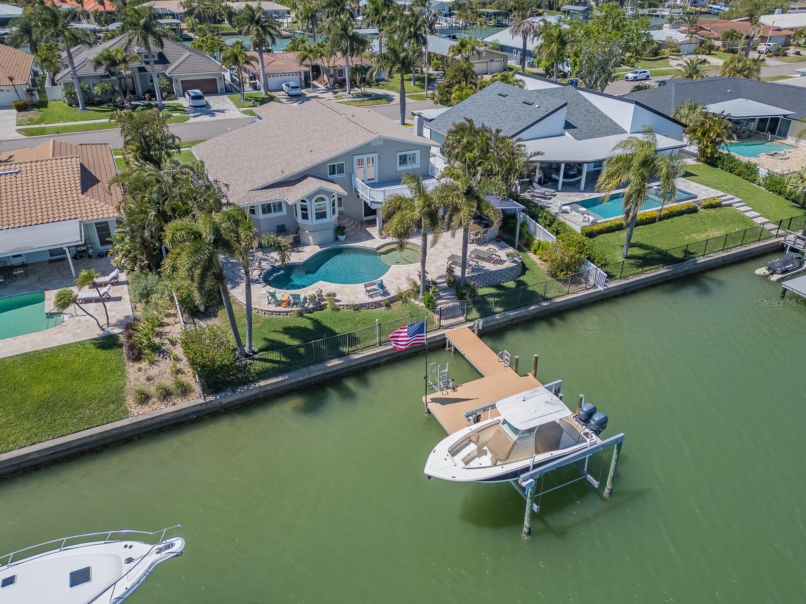 WATERFRONT LIVING AT ITS BEST!
Experience the ultimate in tropical luxury with this stunning 2-story waterfront home. Offering 2 car garage, 3 spacious bedrooms, 3 full bathrooms, and a stylish half bath.  The first floor en-suite features an attached living room for an in law arrangement, home office or even a live in nanny. Featuring hickory hardwood floors throughout, this residence blends contemporary design with warm, natural tones for effortless coastal charm.
Enjoy resort- style living with a oversized pool, outdoor kitchen with built-in seating, and lush surroundings perfect for entertaining or relaxing in privacy. The homes 2023 new roof and 2021 flat roof provide peace of mind, while PGT impact windows and a whole-house water system ensure comfort and security. 
Inside, the 2024 kitchen remodel showcases refined craftsmanship with modern finishes and premium appliances. The kitchen opens to the combined living room dining room with vaulted ceilings. Freshly painted exterior, every detail has been thoughtfully updated for a move- in -ready experience that feels brand new. The second floor features 2 more bedrooms with attached baths. The primary retreat has a huge walk in closet, double sinks with custom vanity, soaking tub with jets and a walk in shower. The primary retreat also has a huge balcony to enjoy your morning coffee while catching every sunrise. This home also features a large dock with 10,000lbs boat lift. 
Located on Island Estates, there is a Publix grocery, post office and gas station along with fine dining and all a short stroll to our famous Clearwater Beach. This Property sits high and dry, didn't flood!
This property captures the essence of coastal sophistication, elegance, low maintenance, and designed for those seeking the ultimate in Island Life. BE SURE TO CHECK OUT MY VIRTUAL TOUR
