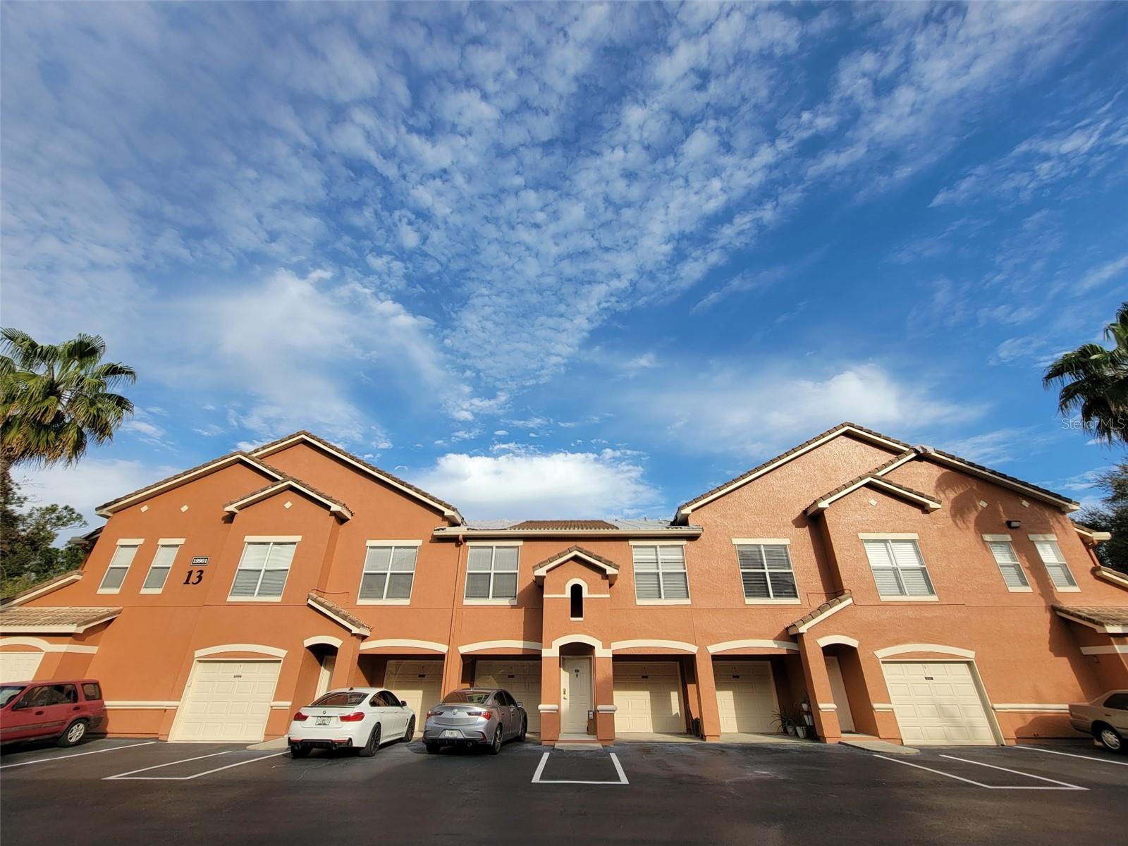 Welcome home to this beautifully maintained 1-bedroom, 1-bathroom condominium featuring an attached private garage and a unique floorplan with ground-floor entry and a private interior staircase leading to the second-floor living space. The open-concept living and dining area creates a bright and inviting atmosphere, perfect for relaxing or entertaining. The spacious bedroom includes a built-in desk ideal for working from home, along with a walk-in closet for ample storage. The well-appointed home also includes a dedicated laundry room with washer and dryer included. Recent updates provide peace of mind, including a new HVAC system, new water heater, and newer refrigerator and dishwasher. Located within a desirable gated community, residents enjoy access to a community swimming pool and beautifully maintained grounds. Conveniently situated near International Drive and Osceola Parkway, this property offers quick access to I-4, world-famous attractions, shopping, dining, entertainment, and everything the Orlando Attractions District has to offer. This move-in-ready condominium combines comfort, convenience, and an exceptional location.