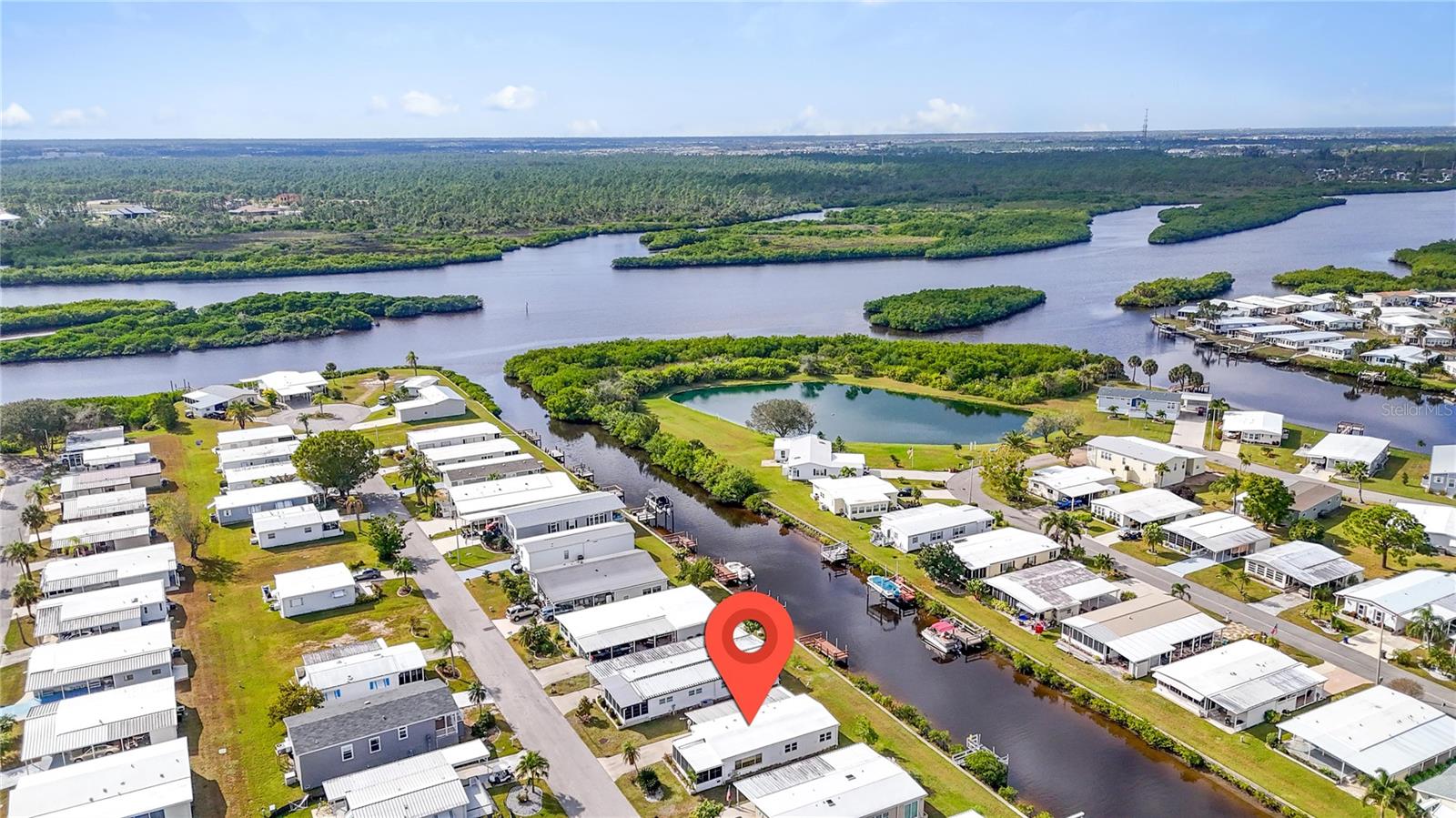 HUGE PRICE REDUCTION and Priced to Move! Don't miss an exceptional opportunity in this 1152 sq ft, 2-bedroom, 2-bath CANAL FRONT home located in the 55+ Harbor Cove waterfront community along the scenic Myakka River. This property is priced to reflect additional updates to the bathrooms and exterior repairs to the roof, carport and lanai ceiling. The AC system and new ductwork were installed in 2024. Inside, you’ll find an open concept with huge living area filled with natural light and a spacious remodeled kitchen featuring stainless steel appliances, plentiful white cabinetry with large soft close drawers and granite countertops with breakfast bar. These stylish updates are extended into the dining area with more built in cabinetry and countertop space, great for serving buffet style. Wake up to peaceful water views from the primary bedroom, complete with an en-suite bath and walk-in closet, while the bright and well-sized guest bedroom sits conveniently across from the hall bath with its updated walk-in shower surround. The enclosed 190 sq. ft. front lanai will need some attention, but it offers valuable extra living space and a great additional spot to relax or entertain. This home is partially furnished and has washer/dryer hookups in the shed under the carport. A long driveway provides plenty of parking for guests or extra vehicles. Put a patio or deck in the backyard and transform it into a private waterfront retreat overlooking the canal. Residents enjoy low HOA fees of just $175 per month and an impressive lineup of amenities: a 90-slip marina, two swimming pools, spa, two-story clubhouse, pickleball and multiple sports courts, plus a full calendar of social events and activities. There may be potential to install a private dock or simply rent a boat slip for only $300 per year.  With boating, fishing, golf, shopping, dining and Gulf beaches all within easy reach, this home offers the perfect blend of lifestyle, location, and value. Home is being sold AS-IS. Schedule a showing today to take a closer look!