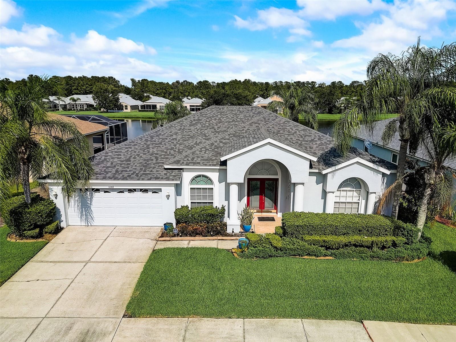 Everyday is a vacation in this spacious home for everyone! This beautiful home boasts a 3-way Split Plan Bedrooms great for privacy, 10' ceilings,  with the fourth bedroom located in its own wing of the house.The gorgeous backyard oasis boasts a crystal blue pool and spa, a covered porch and screened lanai overlooking a serene pond with the kitchen and family room just steps away from your lanai. This home chef's dream kitchen includes an island, double-door pantry, smooth-top range, microwave, tile floors and much more! The owner's bedroom suite enjoys ample space and beautiful views of an exterior escape through sliding glass doors, complete with an oversized walk-in closet, a larger-than-normal shower and a lovely garden tub. Newer roof, air conditioner and numerous updates throughout this home makes it just right for the new owner. Lexington Oaks is an 18-hole golf course community with a golf club and restaurant, also includes a rec center, park, playground, 2 swimming pools, and a day care center. Enjoy living in this beautiful landscaped community with lower Pasco County taxes.  This community is conveniently located near I75, Wiregrass Mall, Shopping, Restaurants, and downtown Tampa. You will love this triple Split Floor Plan and the ample square feet, with so many areas to retreat to if privacy is what you seek.