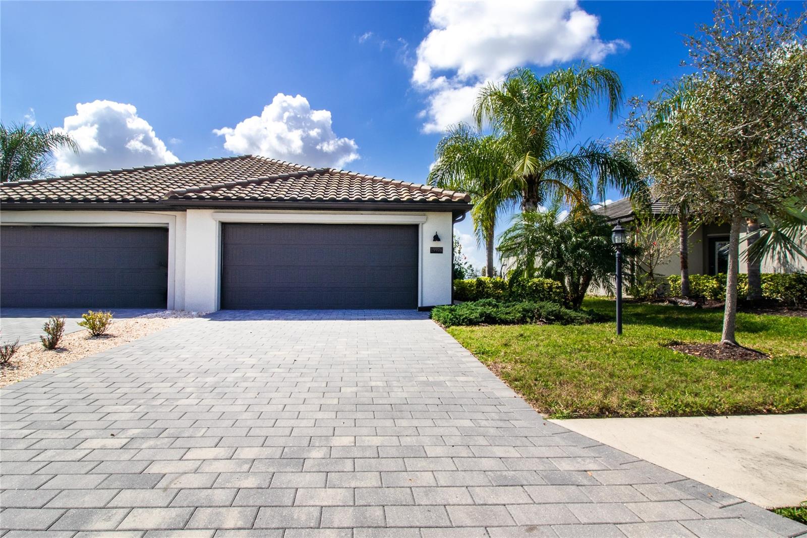 Price Improvement on this Gorgeous 2-bedroom, 2-bath villa with a den, featuring glass doors and an open-concept design (Orchid Floor Plan). The galley-style kitchen flows seamlessly into the main living area, complemented by tile flooring throughout. The living area and primary bedroom have been freshly painted, creating a bright and inviting feel. The spacious primary suite offers a walk-in closet with a custom closet system and an en-suite bath with dual vanities and a private toilet closet.

Enjoy stunning water views from the backyard and screened-in lanai—perfect for relaxing or entertaining. Additional features include soundproofing on the shared wall, pre-wiring for an electric vehicle charger, pre-plumbing for a whole-house water system, and cable and fiber-optic internet included in HOA fees. Located on a quiet cul-de-sac, the home also offers a pavered multi-car driveway and private side walk-up entry.

The community features exceptional resort-style amenities including a grand clubhouse, resort pool with lap lanes and spa, fitness center, poolside café and tiki bar, tennis and pickleball courts, volleyball, bocce, indoor basketball, putting green, splash park, scenic lakes, walking trails, and a full calendar of social activities. Offering easy access to top-rated schools, dining and shopping, and the Gulf Coast’s iconic beaches, this villa provides an unmatched Lakewood Ranch lifestyle.
Lending Incentive: Mortgage Pro Home Loans is offering up to 1% towards Buyer's Closing Costs & up to $600.00 on the property's appraisal fee, Buyer's must meet Lender qualifications. (Mortgage Pro Home Loans, NMLS #1119474 Equal Housing Lender). One or more photos have been Virtually Staged.