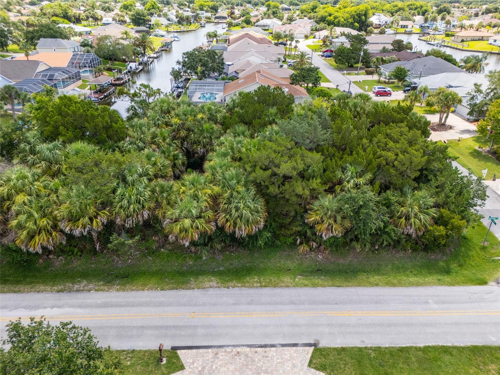 Sailboat Country, no fixed bridges! Build your dream home on this beautiful 15,675-square-foot saltwater canal lot with 40 feet of waterfront frontage in the desirable Palm Harbor "C" Section of Palm Coast. Located on a quiet cul-de-sac and surrounded by attractive homes, this oversized homesite offers the flexibility of no required build time, allowing you to build at your own pace. Conveniently situated near schools, medical facilities, shopping, and dining, the property also provides easy access to miles of scenic walking and biking trails, making it an ideal location for nature enthusiasts and those seeking the perfect blend of waterfront living and everyday convenience.