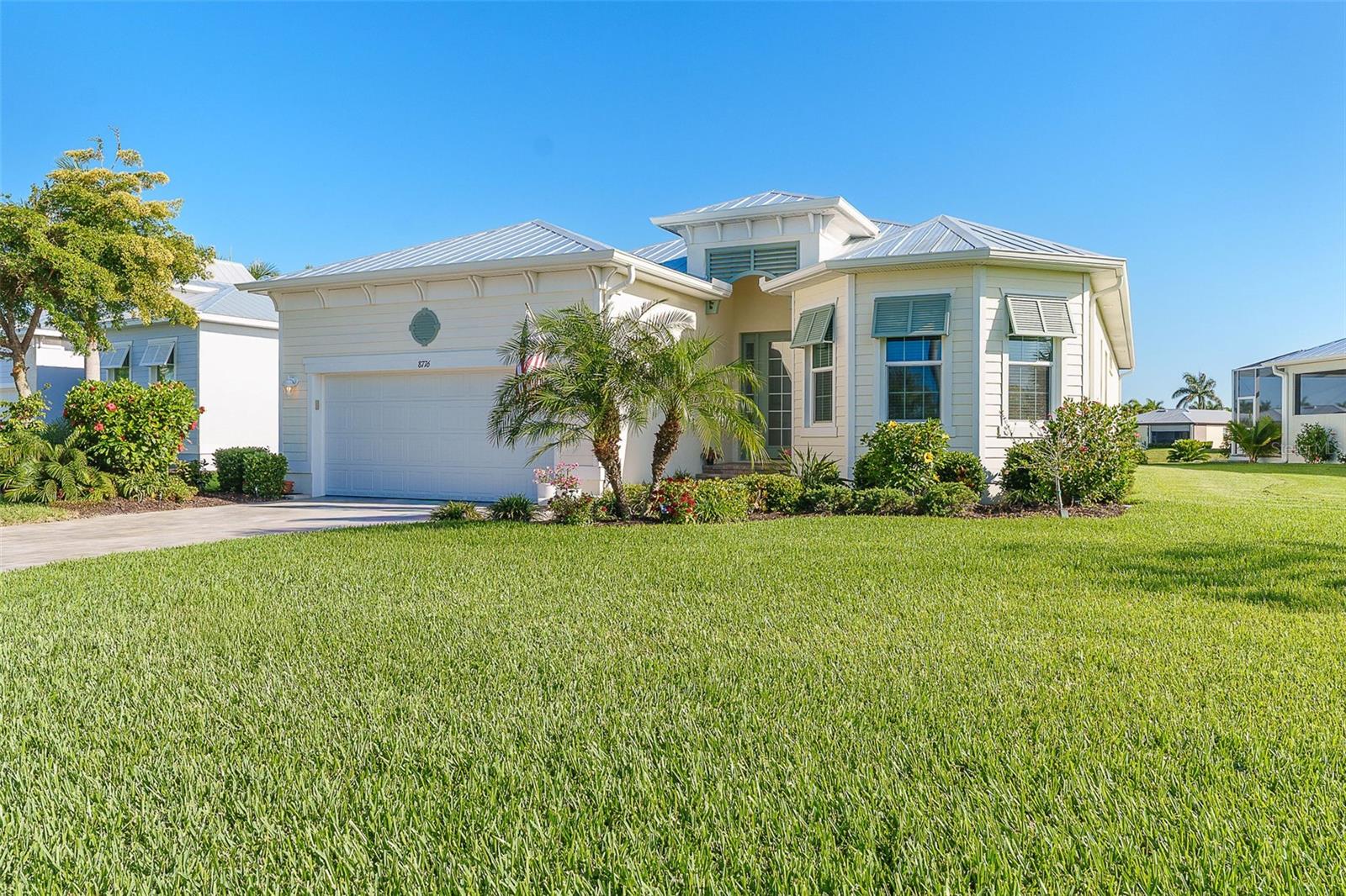 Welcome to your slice of coastal luxury in the highly sought-after gated community of Coral Caye in Placida. Built in 2021, this beautifully upgraded three-bedroom, two-bath home offers 2,151 square feet of thoughtfully designed living space, perfectly blending comfort, style, and functionality. Enter to breathtaking large entry and open concept living, dining room and spacious kitchen with 42" upgraded cabinetry.  Ten-foot ceilings with detailed tray ceiling and crown moldings in both the living area and the primary bedroom.  Living room has expansive open space with extra-large ceiling fan, chandelier and matching pendant lights over extra-large quartz island with additional storage cabinets and beverage refrigerator.  Upgraded light switches in laundry room, pantry, primary closets are motion activated.  Hurricane rated slider, with custom sliding both ways and custom shade which opens onto the oversized extended level lanai — no step down — with upgraded screening to help with insects.  Large six-person hot tub with beautiful lights and fountain for enjoyment.  Pavers were recently sealed, along with the front steps, walkway and driveway which will be good for many years.  Landscaped with beautiful flowering hibiscus and bird of paradise.  Extra-large primary bath with double sinks, large mirror, water closet, comfort height toilet and zero entry shower,  Bedrooms have extra-large closets, front bedroom has additional ceiling fan with remote controlled lighting.  Smoke detectors and CO2 are hardwired alarms.  The kitchen features under-cabinet lighting, and enhanced fixtures, all complemented by stylish beadboard accents and luxury vinyl plank flooring throughout the main living areas. The split floor plan offers privacy for both owners and guests. Additional highlights include crown molding, 8-foot interior doors, upgraded lighting and ceiling fans throughout, and a well-appointed laundry room with utility sink and abundant storage, including a large pantry. Practical upgrades abound with high-impact windows, a durable metal roof, extra insulation for energy efficiency, and a 4-foot garage extension for added space. The home also includes a generator with a dedicated outlet for peace of mind. Even better, the flood insurance policy is assumable, offering additional value and convenience. Residents of Coral Caye enjoy exceptional amenities including a beautiful clubhouse, resort-style swimming pool, pickleball courts, and a fully equipped fitness center—perfect for an active and social lifestyle. Ideally located just moments from Boca Grande, you’ll have easy access to some of Southwest Florida’s most stunning beaches along with world-class boating, fishing, kayaking, scenic bike paths, and hiking trails. Enjoy miles of surrounding waterways, charming local restaurants, and boutique shopping that make this coastal area so special. This exceptional home combines modern upgrades, thoughtful design, and picturesque surroundings—an ideal opportunity to enjoy the very best of Florida coastal living.