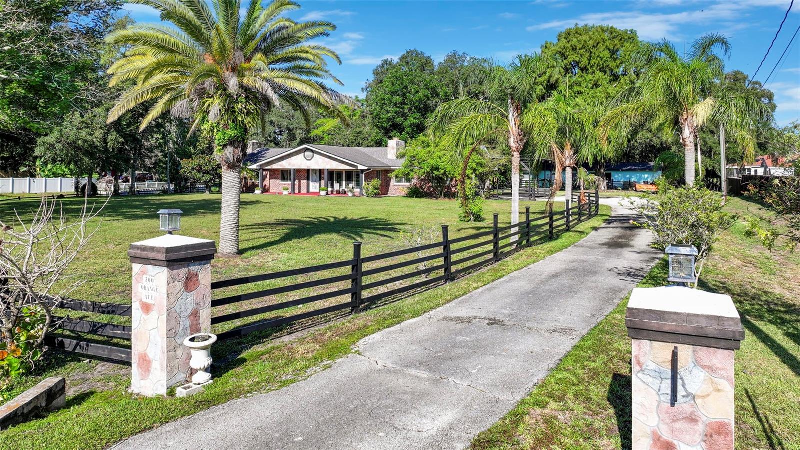 A truly rare opportunity to own a private estate in the heart of St. Cloud. Situated on 1.64 picturesque acres beneath a canopy of majestic, centuries-old oak trees, this exceptional property offers the perfect balance of privacy, functionality, and endless possibilities. All while being just minutes from everyday conveniences. What makes this property truly stand apart is the presence of two fully independent residences on one parcel, creating an unmatched opportunity for multigenerational living, guest accommodations, rental income, or a private retreat.

The main residence features 4 bedrooms and 3 full bathrooms with beautifully updated bathrooms, ceiling fans throughout, tiled flooring, and its own water softener system. The second home offers 2 bedrooms and 2 full bathrooms, a nice kitchen, providing comfortable and private living for extended family, guests, or tenants.

The outdoor spaces are where this estate truly comes to life. At the center of the property, a spacious courtyard creates the ultimate gathering place, featuring a stunning wood-burning fireplace, a covered outdoor living area, and plenty of room to entertain year-round. Just beyond, an elevated wooden deck overlooks the tranquil landscape, offering the perfect setting to enjoy morning coffee, evening sunsets, or simply the peaceful surroundings.

Bordering the southern edge of the property is a scenic shared pond that enhances the natural beauty and serene atmosphere. Towering oak trees shade much of the property, creating a breathtaking park-like setting rarely found this close to town.

Whether you're searching for a family compound, an investment opportunity, a place to comfortably accommodate multiple generations, or simply a property with room to live, grow, and create lasting memories, this estate delivers a lifestyle that is increasingly difficult to find.

With over 1.6 acres, two homes, incredible outdoor living spaces, mature landscaping, and an unbeatable location in the heart of St. Cloud, this is far more than a home- it's a property filled with opportunity, flexibility, and timeless Florida charm.