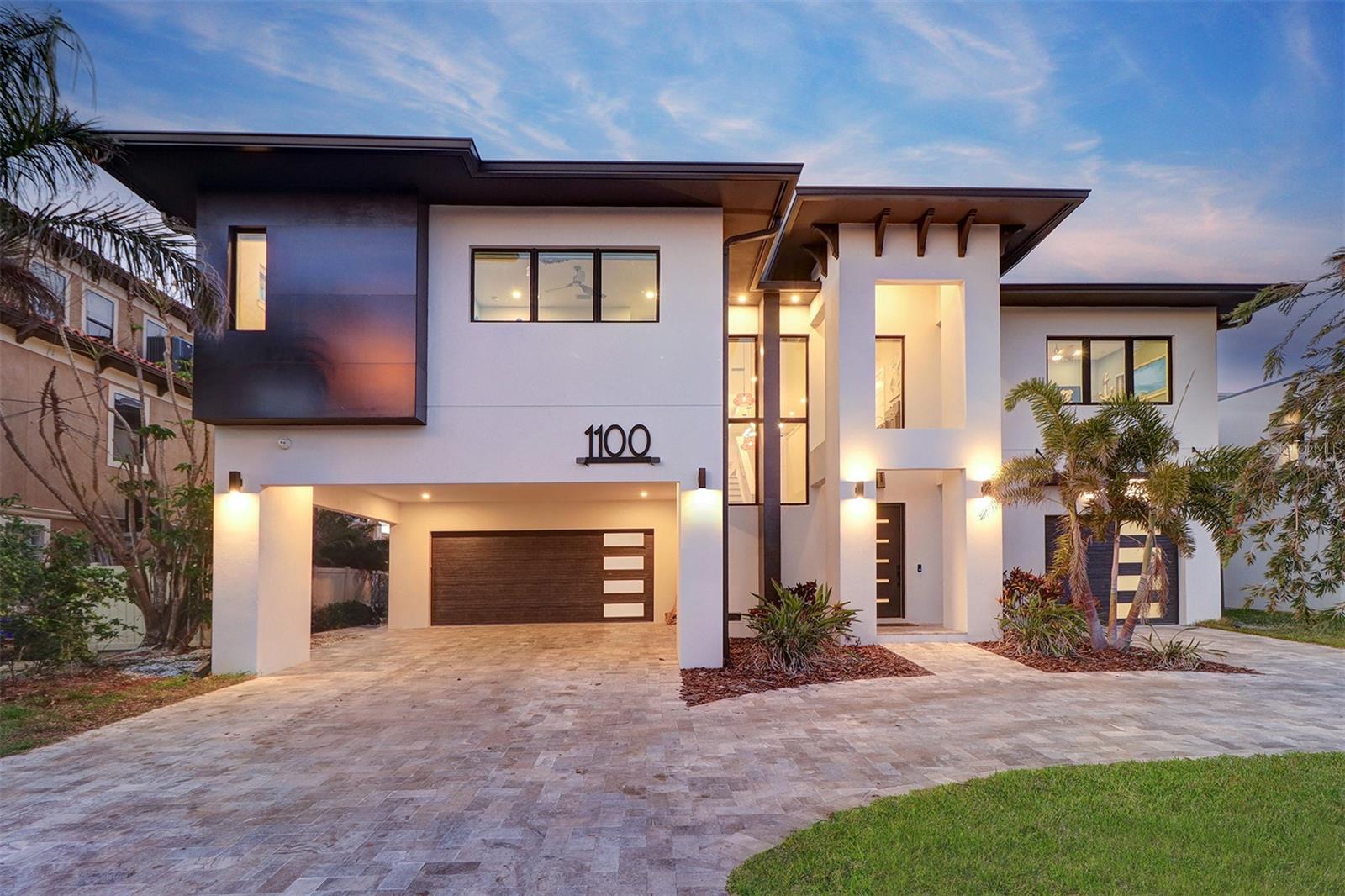 NEW PRICE.......18FT ELEVATION -CUSTOM BUILT WATERFRONT POOL HOME. Welcome to an unparalleled luxury residence that redefines elegant living. This stunning custom-built home, completed in 2022, is a masterpiece of design and craftsmanship, exceeding all fema building regulations. Nestled in an exclusive neighborhood, this 4-bedroom, 3 1/2 bathroom estate features all masonry block construction,Steel and concrete floor trusses providing not only exceptional durability but also a sophisticated aesthetic with high quality imported wood-look tile throughout. The striking elevation showcases an impressive façade adorned with refined architectural elements, creating an inviting first impression. Step inside to be greeted by an expansive open floor plan, bathed in natural light and highlighted by high tray ceilings and exquisite finishes. The grand living area seamlessly flows into a state-of-the-art gourmet kitchen, complete with premium stainless steel appliances including an induction Miele cooktop, elegant and maintenance free waterfall Curava countertops and custom cabinetry—ideal for the discerning chef and perfect for entertaining sophisticated gatherings. Each of the 4 generously sized bedrooms is a sanctuary of comfort, with the opulent primary suite offering a private retreat. Indulge in the luxurious ensuite bath, featuring dual vanities and toilets, a deep soaking tub, and a spacious rain shower, all crafted with the finest materials for an unparalleled spa-like experience.
The additional bathrooms are equally impressive, blending functionality with high-end design. Outdoors, the meticulously landscaped grounds with the resort like pool complete with a beach-entrance provide a tranquil escape, with a lavish travertine covered patio that invites you to savor serene evenings or host extravagant outdoor soirées with breathtaking sunset views. Surround sound and even underwater speakers in the pool. Lots of room for hobbies, storage etc. in the downstairs area. A 51 solar-panel system powers the entire home including the pool and EV charger. Oversized garages, carport and driveway provide parking for up to 11 vehicles.
Situated in a prime location, this home is just moments away from the world famous St Pete Beach  unigue shopping and one-of-a-kind  restaurants ensuring the perfect balance of luxury and convenience. Don’t miss the opportunity to experience this exceptional property, schedule your private showing today and step into a world of refined elegance! Bring your pickiest Buyer this home will not disappoint.