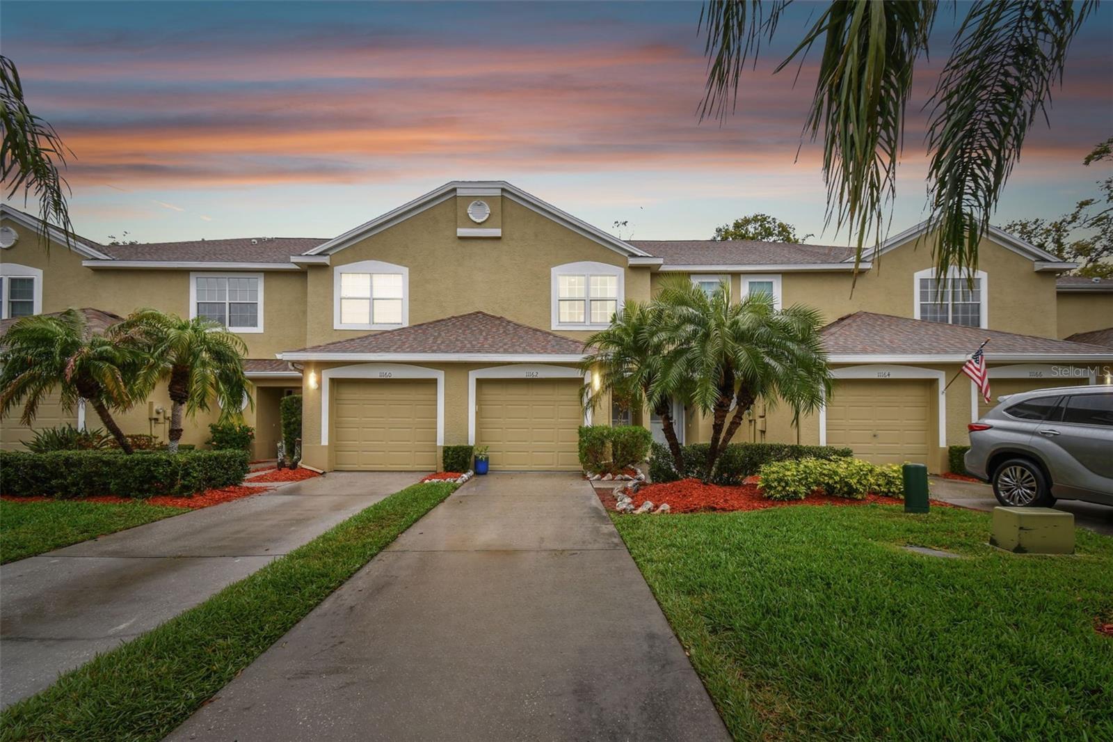 Just 1.7 miles from Madeira Beach, this beautifully updated townhome in the gated community of Kapok Grand offers the perfect blend of modern updates, low-maintenance living, and peace of mind. Take advantage of a seller credit that can be used toward your closing costs or an interest rate buydown with an acceptable offer, making this move-in-ready home even more affordable.

The completely redesigned kitchen (2026) was opened up to create the ideal entertaining space, featuring new granite countertops, a brand-new refrigerator, and an expanded breakfast bar overlooking the spacious dining and living areas. Triple sliding glass doors fill the home with natural light and lead to a private screened lanai surrounded by lush greenery—perfect for morning coffee, evening relaxation, or enjoying Florida’s beautiful weather.

Upstairs, both oversized bedrooms feature their own private en-suite bathrooms, offering an ideal layout for guests, roommates, families, or working from home. The primary suite is a true retreat with vaulted ceilings and a fully remodeled spa-inspired bathroom (2026) showcasing shaker cabinetry, matte black finishes, and a frameless glass walk-in shower. The secondary suite includes dual closets and its own private bath, while the upstairs laundry adds everyday convenience.

Major updates include luxury vinyl plank flooring (2025), a new A/C (2024), washer, dryer, dishwasher, and refrigerator. Even better, the home has no flood history and comes with low-cost transferable flood insurance, providing valuable long-term savings and peace of mind.

Residents of Kapok Grand enjoy a gated entrance, heated and chilled community pool, scenic walking trails, abundant guest parking, and an unbeatable location just minutes from Madeira Beach, Seminole City Center, shopping, restaurants, and everyday conveniences.

Whether you’re searching for a primary residence, vacation getaway, or investment opportunity, this fully updated townhome offers the Florida lifestyle you’ve been looking for